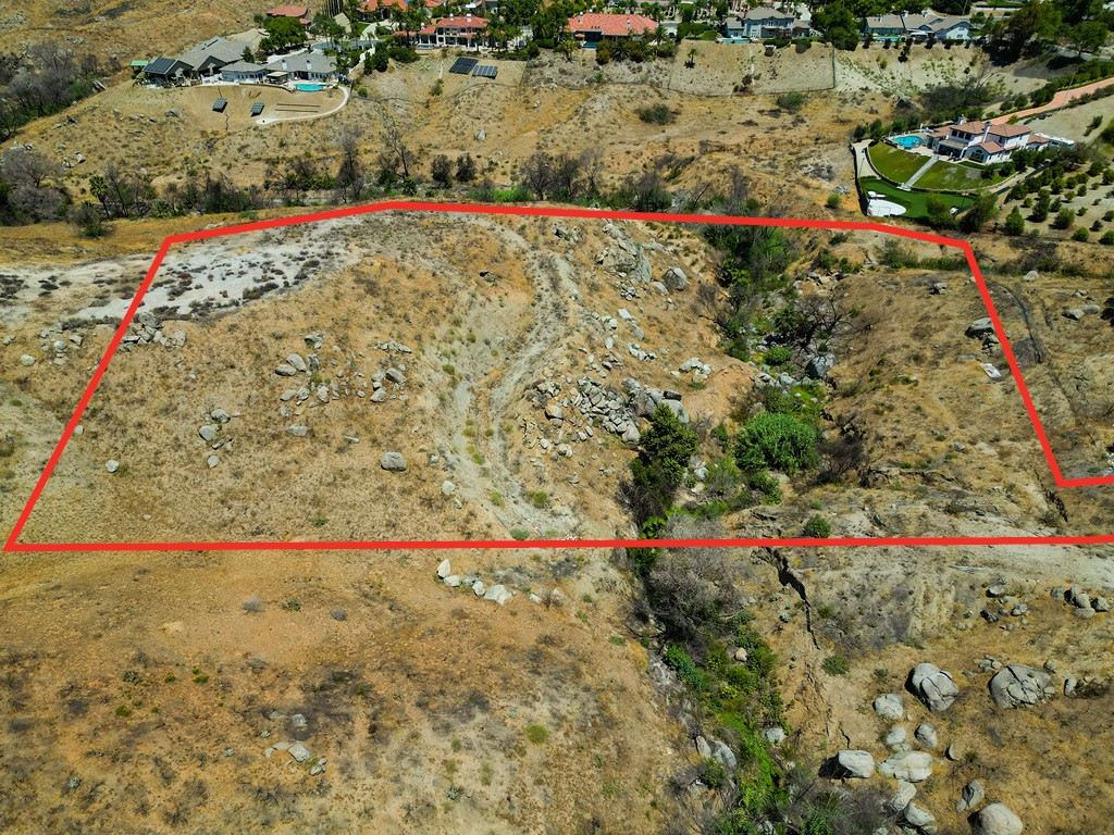This parcel of over six acres is in the Canyon Crest neighborhood and has a beautiful arroyo/creek that runs through it. The entrance is gated and the long driveway is fenced until you get to the bulk of the acreage which is open space.