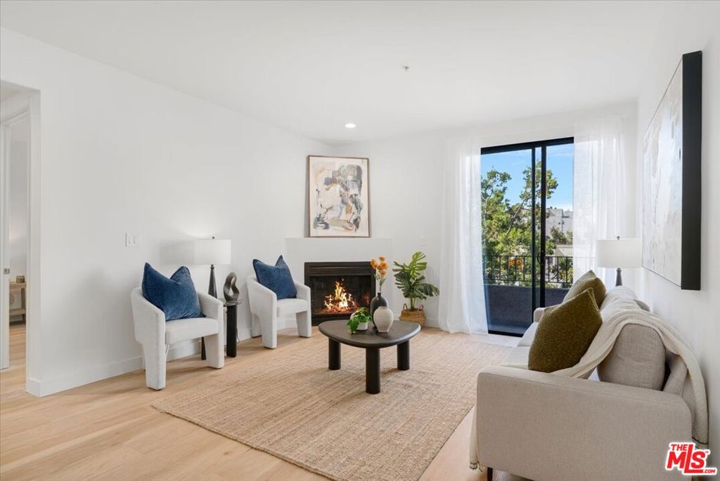 Discover this one-of-a-kind, fully remodeled 3-bedroom, 2-bathroom condo in the heart of Koreatown. At 1,340 sq ft, this unit offers a spacious, light-filled layout with the only wrap-around balcony in the building perfect for indoor-outdoor living. The unit has been thoughtfully renovated throughout with brand new appliances, modern flooring, fresh paint, updated bathrooms, Nest thermostat and contemporary fixtures. A cozy fireplace anchors the open living space, creating a warm and inviting atmosphere. The functional floor plan offers generous room sizes and excellent natural light in every room. Located in a secure building with 24-hour security, residents also enjoy access to a fitness center, 2 dedicated parking spaces, and ample guest parking. Step outside and you're surrounded by Ktown's best cafes, restaurants, nail salons, and eateries literally just downstairs. This is an incredible opportunity to own a rare unit in a prime location where lifestyle and convenience meet.