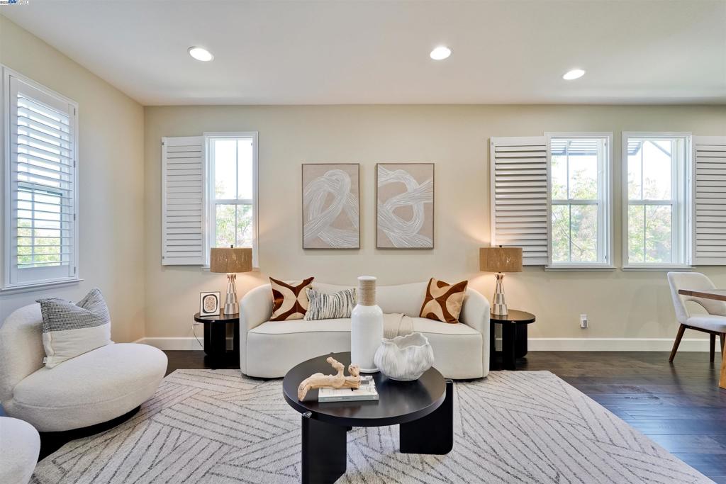 Discover modern elegance in this bright 2015 end-unit townhome, perfectly situated in Fremont's upscale Mission San Jose neighborhood. Boasting 4 bedrooms and 3.5 bathrooms, spanning an impressive 2,108 square feet across three levels. This Summerhill home features an open layout filled with natural light. A convenient ground-floor bedroom and full bathroom offer the perfect private retreat for guests or a potential home office. The main level welcomes you with a gourmet kitchen, complete with a large island, stainless steel appliances, and a new Bosch cooktop. Upstairs, the luxurious primary suite features a spacious walk-in closet and a spa-like bathroom with dual vanity sinks. The home includes central heating and cooling, fresh interior paint, recessed lighting, in-unit washer and dryer, elegant shutter blinds, rich Boca Brich hardwood flooring, and an EV charging outlet in the spacious two-car garage. Set on a private corner lot, the home enjoys open, scenic views of the majestic Mission Hills and exceptional tranquility. The home is within walking distance to the top-rated Mission San Jose School District (Gomes Elementary, Hopkins Jr. High, and Mission San Jose High) and offers easy access to freeways 680/880, shopping, and dining.