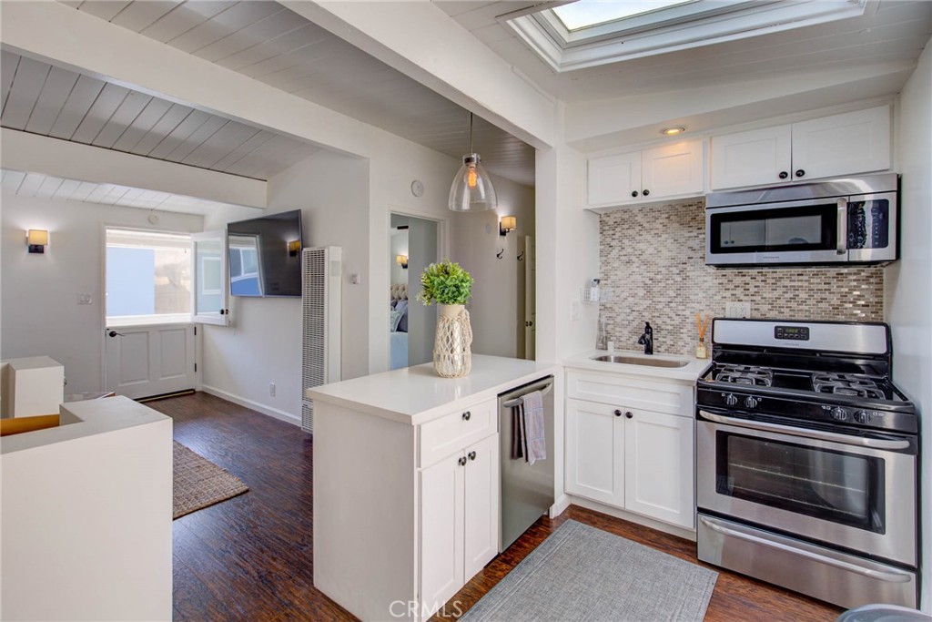 Welcome to 217 35th Place, a stunning fully furnished 2-bedroom, 1-bath residence located in the heart of the Sand Section in Manhattan Beach. Just steps from the beach and within walking distance to the area's premier shopping, dining, and entertainment, this beautifully remodeled unit offers the ultimate in coastal living. The home is part of a charming two-unit building and features a modern kitchen with stainless steel appliances, and tasteful furnishings that make moving in effortless. Enjoy breathtaking panoramic ocean views from the rooftop deck—perfect for relaxing, entertaining, or taking in unforgettable sunsets. Additional amenities include a private laundry area, one-car garage parking, and included beach gear for your convenience. All utilities are covered, so you can settle in and enjoy the Manhattan Beach lifestyle from day one. This turnkey home delivers comfort, style, and unbeatable location.