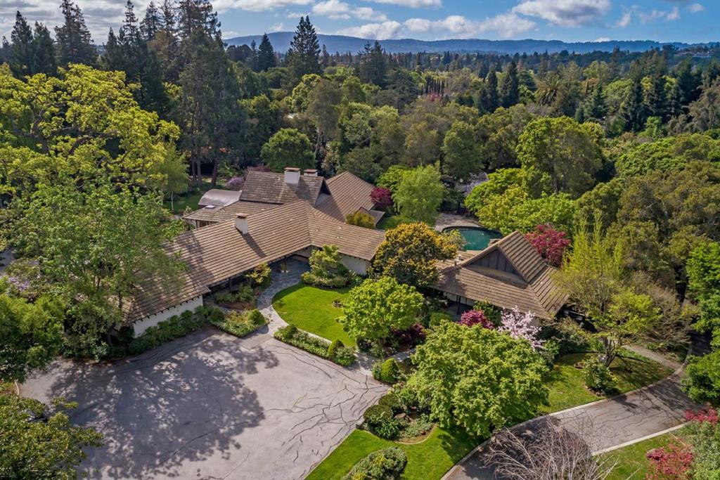 A rare opportunity to remodel or build new on approximately 2 acres in the heart of west Atherton. Set back from the street with amazing privacy, the property includes an of-the-era glamorous mid-century home, separate guest house, plus pool, spa, and magnificent gardens. The level corner lot is dotted with mature heritage trees and colorful foliage, all beyond a private gated entrance. The home has access to excellent Menlo Park schools and is perfectly located midway between San Francisco and Silicon Valley.