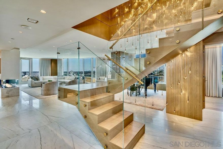 Welcome to Penthouse 4 — a one-of-a-kind trophy residence that redefines elevated living. Meticulously reimagined with the most exquisite finishes available, this architectural masterpiece offers a level of luxury rarely seen and never to be duplicated. Step inside your private elevator and ascend to a world of sophistication. The moment you enter, you’re greeted by soaring ceilings, radiant quartzite flooring, and an expansive open-concept living and dining space, all framed by breathtaking, unobstructed views stretching over San Diego and beyond. Watch the planes land at San Diego International as if floating in a dream — it’s a view you’ll never tire of. No detail has been overlooked. From the custom La Cornue range to the floating glass staircase and dual-level private elevator system, every feature has been designed with intent, craftsmanship, and absolute opulence. The main level offers a sleek guest suite and full bathroom, ideal for guests or a home office. Ascend to the second floor to find two stunning ensuite bedrooms adorned with bespoke cabinetry and rich marble details. The crown jewel of the home is the primary suite — a sanctuary in the sky — featuring jaw-dropping panoramic views, couture-level finishes, and a boutique-worthy walk-in closet that will take your breath away. Perfectly positioned overlooking Balboa Park and just minutes from San Diego’s top restaurants, cultural destinations, and the airport, Penthouse 4 offers not only luxury, but lifestyle — seamlessly connected, yet peacefully above it all. This is not just a home. This is an experience.