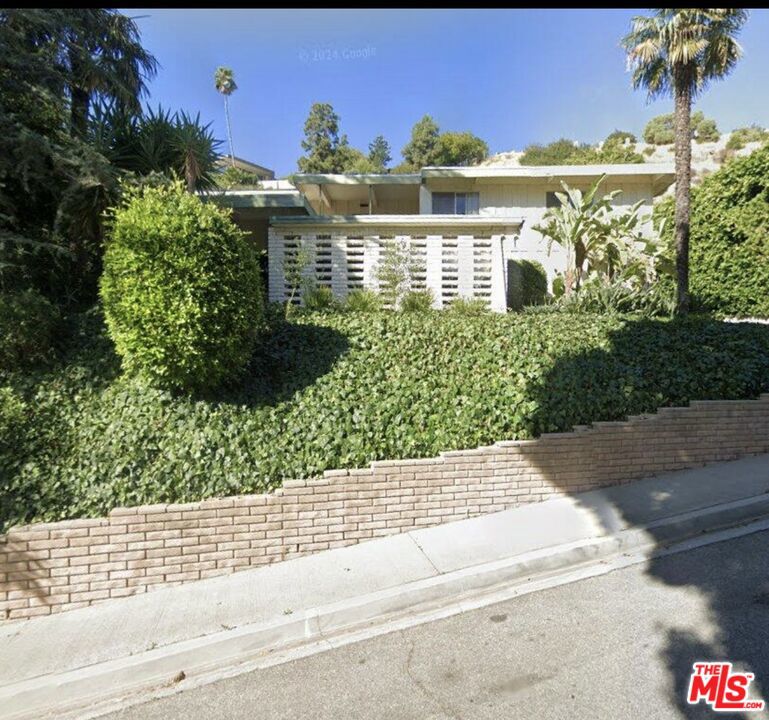 Two-story Mid-century home w/pool. Sprawling lot with usable land to expand. 3 car attached garage w/4 car driveway parking. Foyer entry with marble flooring and in-ground planters. Entry level includes office/den w/patio, formal living and dining rooms w/patios, kitchen, family room, maid's quarter, 2 bathrooms, laundry room and garage entry. Second floor consists of Master bedroom w/ private deck/balcony and in-suite bathroom, 2 bedrooms with jack and jill bathroom entry plus patio space. Second floor laundry chute w/ high ceilings and sliding doors throughout. Backyard is filled with resilient shrubs; fruit trees and trees that are all quickly re-sprouting!