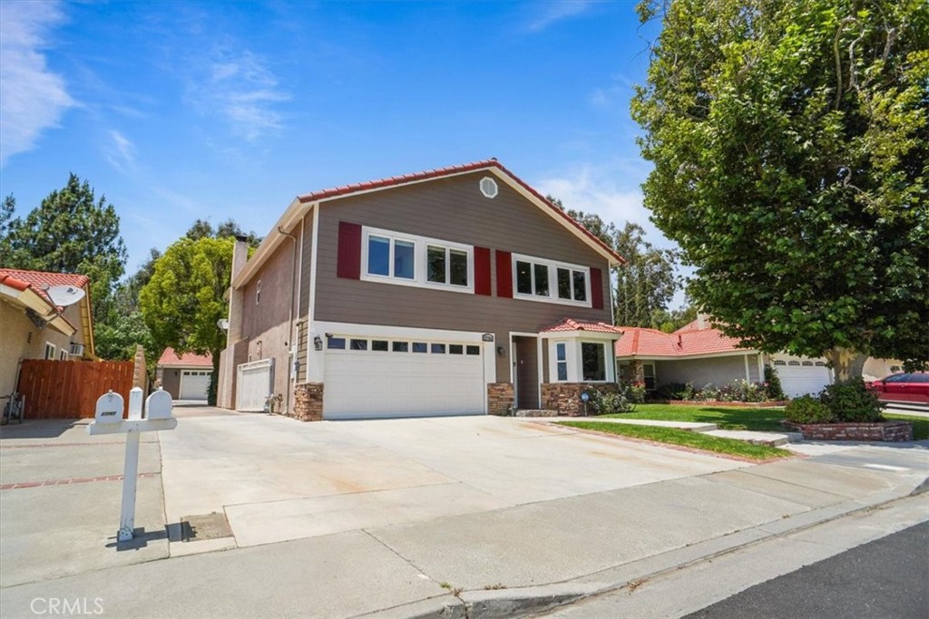 Absolutely, Immaculate Remodeled home with a "separate" 1200 sq. ft. 4-Car Garage which could be a workshop or potential guest house/ADU, RV/Boat Access & minutes from Castaic Lake, Magic Mountain & all of the Santa Clarita amenities! Welcome to this beautifully upgraded 4-bedroom, 2.5-bathroom home. Every inch of this 2,400+ sq. ft. home has been thoughtfully renovated with luxury, functionality, and timeless design in mind. There is a large home office, vaulted ceiling in the living and dining room filled with natural light and serene backyard views. The stunning custom built kitchen features soft close cabinetry with pull outs. It has Cambria quartz counters, upgraded stainless steel appliances, and LED lighting. The adjacent family room and half bath also boasts custom built-ins, and a cozy wood burning fireplace for effortless entertaining. Upstairs, you’ll find four extra large, spacious bedrooms, including a newly remodeled hall bathroom with soaking tub and shower. The luxurious primary suite has a spa-like shower with dual heads, dual sinks, and custom; soft-close cabinetry with Cambria quartz throughout. One of the bedrooms is currently used as a second family room with built-in cabinetry, a sink, and large closet space—ideal as a media room, game room, workout room or guest retreat. The backyard is an entertainer’s dream with a private deck off the primary bedroom, professional landscaping, a dog run, and a gated concrete driveway. A permitted 1,200 sq. ft. detached 4-car garage—perfect for a workshop or future ADU/guest quarters, car collector etc. Key Upgrades Incl: Owned $40,000 solar system, dual-pane Milgard windows, a new Tankless water heater with on demand hot water, a full-home reverse osmosis system (w/250-gallon tank), dual A/C units (one brand new in 2025), "Hardie" siding & fresh exterior paint, brand new plush carpet, crown molding & hardwood floors (Teak) in the bedrooms. Meticulously maintained and packed with high-end upgrades, this home is truly move-in ready. A supplemental list of all improvements is available—schedule your private tour today! No HOA, CC'R's, and no MellaRoos.