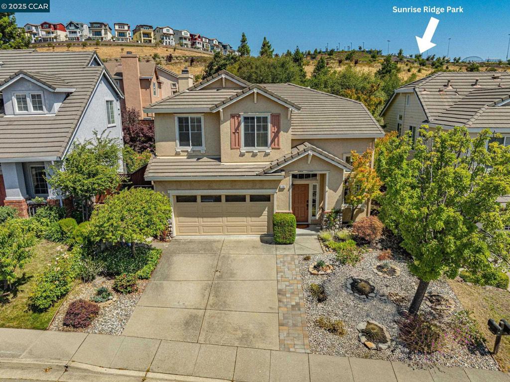 Discover the perfect blend of nature, convenience, and style in San Ramon’s sought-after Deerwood community. Just steps from a neighborhood walking path leading to Sunrise Vista Park and near scenic Las Trampas Regional Park, this home offers a seamless connection to nature, yet is just minutes away from shopping, award-winning San Ramon Valley schools, the vibrant San Ramon City Center and easy commute access. Step inside to soaring ceilings, rich engineered hardwood floors, and an abundance of natural light welcoming you into the expansive living and dining rooms. The bright, sunlit kitchen has been beautifully refreshed with new quartz countertops, crisp white cabinetry, and a sleek stainless-steel French-door refrigerator, opening effortlessly to the family room with a pellet stove fireplace insert for cozy evenings at home. Upstairs, plush new carpeting leads to four spacious bedrooms, including a generous primary suite with serene hillside views. The ensuite bath features a soaking tub, separate shower, dual vanities, and a huge walk-in closet. Enjoy low-maintenance curb appeal with a drought-tolerant front yard, while the peaceful backyard backs to open space, offering extra privacy for entertaining or relaxing. Don't miss this opportunity in an unbeatable location!