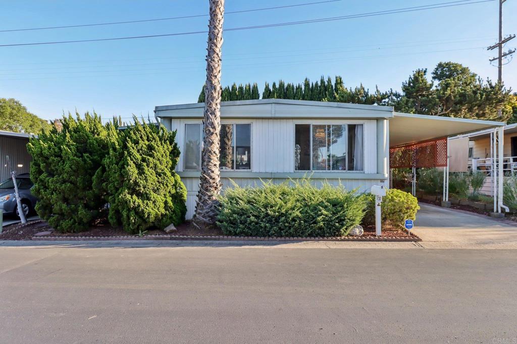 Welcome to this spacious 2-bedroom, 2-bath manufactured home offering 1,440 sq. ft. of comfortable living in the desirable San Marcos Mobile Estates. The light filled living room features fresh carpet installed in 2024, creating a warm and inviting space to relax or entertain. The floor plan flows seamlessly into the dining area and kitchen, providing plenty of room for gatherings. Both bedrooms are generously sized, with the secondary bathroom upgraded to a new shower/tub in 2025. The plumbing was jetted and cleared out to the city connection in November of 2024, along with a new water heater installed in December of 2024. The stairs to the front door in the carport were recently rebuilt, and all of the door knobs have been replaced as well. Relax on the side porch with the built in misters on a hot day, or enjoy the parks amenities and relax at the sparkling pool and relaxing spa - perfect for enjoying Southern California's weather. Don't miss this opportunity to own a well-maintained home in a friendly community close to shopping, dining, and freeway access.