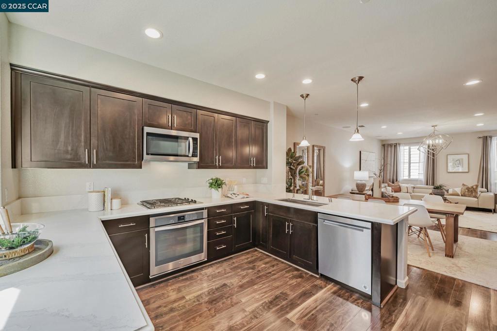 Gorgeous North-Facing Home in Prime Dublin Location! Welcome to this beautifully upgraded 3bed, 2.5bath home, ideally situated at the end of a quiet cul-de-sac in the desirable Emerald Vista community. This home features an open-concept layout with soaring ceilings, recessed lighting, elegant centerpiece chandelier & durable laminate wood flooring throughout the main living areas. Spacious living room includes built-in speakers, perfect for entertaining. Gourmet kitchen boasts rich espresso cabinetry, SS appliances, ample counter space & spacious walk-in pantry. Smart home upgrades include Nest Doorbell, Nest Thermostats, and smart light switches. Ground-level bonus space offers flexibility for a home office, gym, or playroom. 3 generously sized bedrooms in the upper level provide comfort and privacy. This move-in-ready home includes washer/dryer, refrigerator & water softener. Minutes from shops & restaurants - Persimmon Place, Hacienda Crossings & SF Premium Outlet. Easy access to I-580/I-680 & Dublin/Pleasanton BART. Low HOA ($273/mth), excellent location, and modern upgrades make this home a must-see!
