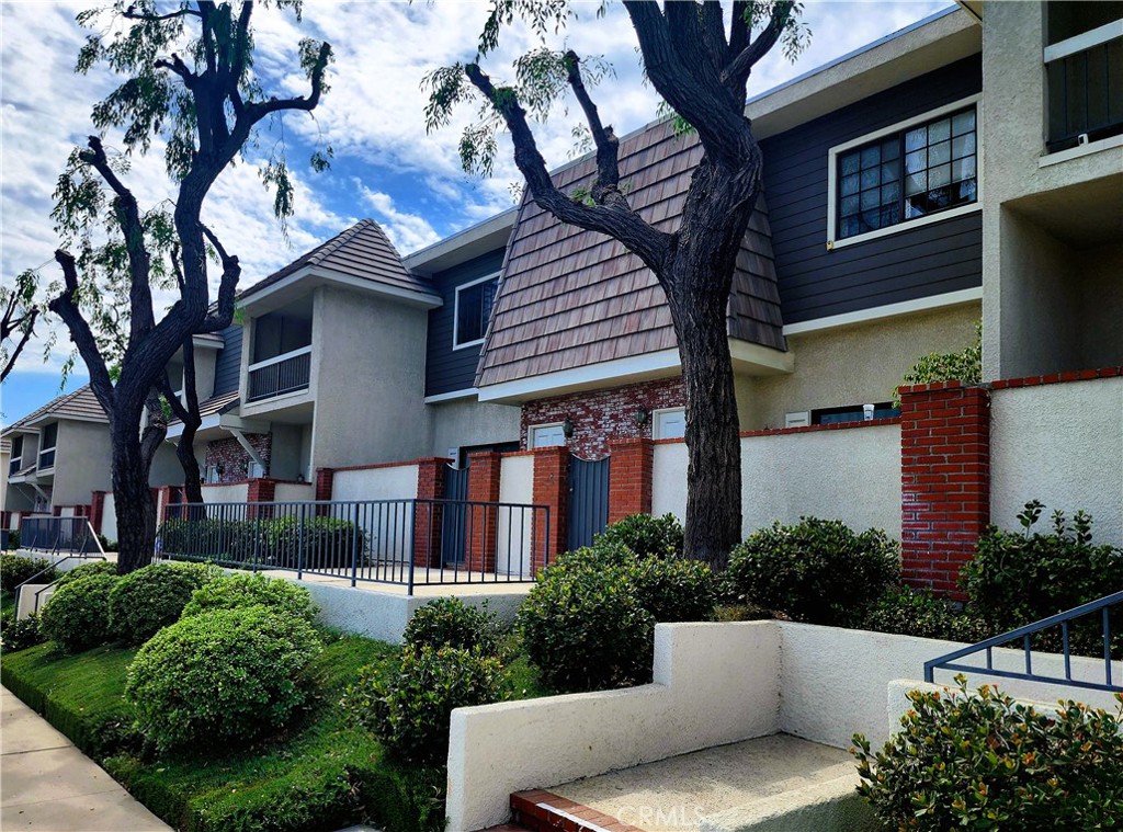 Prime, Move-in Ready Townhouse in the Coveted Mason Grove Community. This beautifully remodeled tri-level townhouse blends comfort and style in a desirable open split-level layout. Boasting 2 bedrooms, 2.5 baths, and an attached 2-car garage, this home checks every box. Step into a welcoming entry way featuring a custom built-in wood cabinet-perfect for a dry bar-that opens into a stunning living area with soaring ceiling, recessed lighting, and ceiling fan. From here, enjoy direct access to your own tranquil private patio. A short set of steps leads to the formal dining area, accented by a mirrored wall, which seamlessly flows into the sunlit eat-in kitchen. Here you’ll find new quartz countertops, top-of-the-line appliances, a built-in desk, and—you guessed it—abundant cabinetry to meet all your storage needs. The main level also includes a renovated powder room and access to the finished double garage, complete with a storage room. Upstairs, two expansive en-suite bedrooms offer walk-in closets and private bathrooms. The primary suite features a spa-inspired bath for relaxation. Both bedrooms are outfitted with double windows and ceiling fans for comfort and quiet. Additional highlights include new waterproof wood flooring throughout and a laundry area with linen storage between the bedroom suites for added convenience. As a resident of Mason Grove, you’ll enjoy great amenities, including a recreation clubhouse, two sparkling pools, hot tubs, and a rejuvenating sauna. All this, plus an excellent location close to The Vineyards at Porter Ranch, CSUN, top-rated schools, Trader Joe’s, and an array of popular restaurants, markets, and shops.