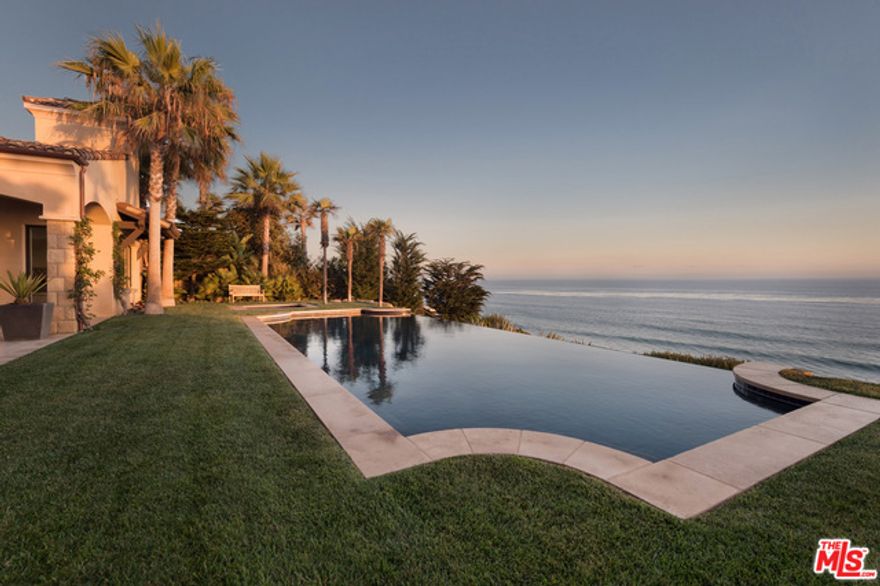 Oceanfront vistas await at The Spanish Estate, an incomparable residential retreat perched on a private bluff top in Malibu's exclusive Marisol community. Masterfully designed by award-winning architect Barry Berkus A.I.A, this earthly paradise offers clear views of the Pacific the moment you pass through the great room's soaring 16' foot ceilings. Nighttime reflections of a star-filled sky can be seen in the 50-foot infinity edge pool, which seamlessly blends into the horizon stretching as far as Catalina Island. Dual master suites take advantage of the sun's arc across the sky and feature gallery-style walk-in closets. A sheltered courtyard spanning 3,200 sq ft. entertains with a wood-burning fireplace, BBQ, and lounge areas. An acre of immaculately restored coastal land lends a pristine, natural playground all to yourself, while world-class surfing and parasailing awaits by the water's edge. 20 minutes from your private plane at Camarillo airport to the door of this Malibu Estate.