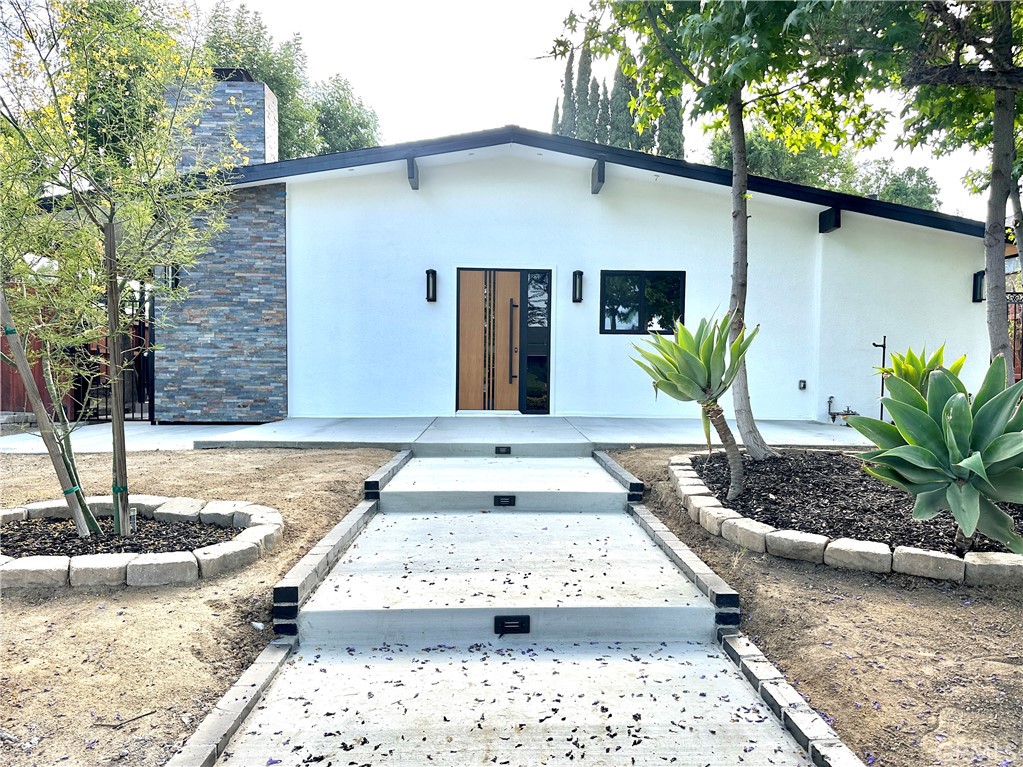 This beautifully remodeled Granada Hills residence is situated on a desirable cul-de-sac street, & is in the desirable Granada Hills Charter High School district. The home features a modern main entrance, sleek lines & beautiful curb appeal. The home was recently remodeled with upgrades including quality cabinetry in the kitchen with pantry space, quartz counter tops, stainless steel appliances, & gold finished hardware throughout. The home has high ceilings & is filled with natural light. Recessed lighting, natural wood-colored tones & beautifully designed fireplace creates a warm & inviting atmosphere. The bathrooms feature modern fixtures, glass shower doors, custom tile showers & new vanity sink combos for storage and style. Additional improvements include a recently upgraded central AC system, new copper plumbing, and energy-efficient dual-pane windows, ensuring long-term comfort and energy efficiency. Outdoor spaces include a new large covered patio ideal for entertaining. The home is centrally located near major freeways, parks, shops, restaurants & top ranked schools.