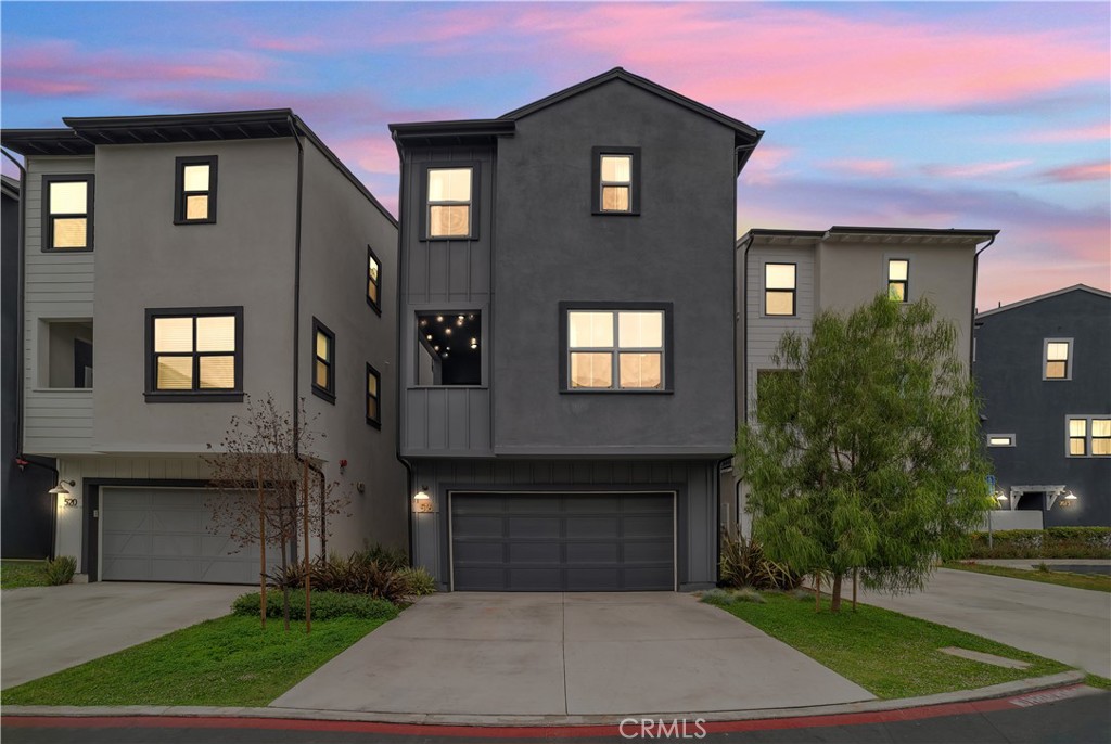 Welcome to Twenty8 Walk, a private gated enclave of detached condos in the heart of vibrant Costa Mesa. This stunning residence features one of the community’s most coveted floor plans, enhanced by designer upgrades and smart-home features throughout. The entry level includes a spacious en-suite bedroom with direct access to a beautifully landscaped yard (the largest in the development) complete with custom hardscape, a lush garden, and a built-in sprinkler system—an inviting retreat, office or ideal guest space. The attached two-car garage includes a Tesla charger port. Upstairs, the open-concept main level is an entertainer’s dream, showcasing a chef’s kitchen with Arabescato Como quartz counters and backsplash, a generous island with bar seating, soft-close shaker cabinetry, a Western Pottery farm sink, and a built-in wine cooler. Premium Samsung stainless steel appliances, a Moen matte black fixture suite, and a reverse osmosis water system add both style and function. The spacious great room is fitted with an upgraded audio package featuring in-ceiling speakers, plus access to a private enclosed balcony and a convenient powder room. The top floor offers a luxurious primary suite with a walk-in closet and an upgraded spa-style bath with a frameless glass enclosure and oversized 10" rain shower head. Two additional bedrooms share a stylish Jack-and-Jill bathroom, and the home features upgraded Heritage Collection interior doors throughout. Additional highlights include a Nest Hello doorbell, leased solar system, and a Samsung smart washer and gas dryer (negotiable). Ideally located minutes from Newport Beach, top schools, shopping, golf, and dining, this turnkey home blends modern luxury with everyday comfort.