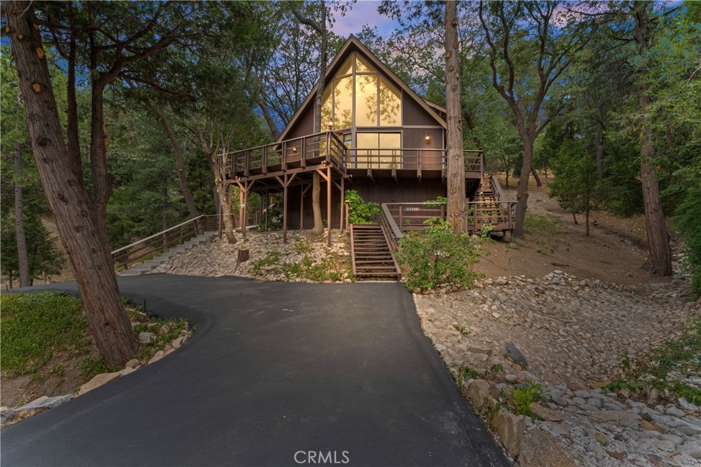 Welcome to Beautiful Lake Arrowhead, this Lake Rights home is the one!
Located on the sought-after Alpen Drive, just a short walk to the lake and North Bay, this mountain retreat is the perfect getaway.
Arrive to a freshly paved level driveway (room for 2–3 cars) and follow tiered steps up to a bright, open living space with soaring A-frame ceilings, grand windows, and a welcoming kitchen. The main level offers two bedrooms and a full bath, including one with its own private deck and yard access plus full home A/C. Upstairs, the spacious loft-style primary suite features vaulted ceilings, abundant natural light, a walk-in closet, and ensuite with dual sinks.
Enjoy a partial wrap-around deck, natural landscaping, and a seasonal stream that flows alongside the property. From the moment you enter, you’ll feel right at home. Don’t miss this charming Lake Arrowhead retreat!