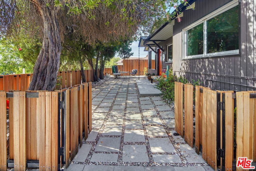 Fixed atop a hill on the border of Highland Park & Eagle Rock is this charming mid-century jewel featuring panoramic views from just about every inch of the property, inside & out. The many upgrades in the home keep it feeling clean and current while embracing the original charm & character of another time. The shaded and spacious courtyardspanning the front of the home is as inviting as the home itself. The light and brightliving room includes a large picture window and flows seamlessly to the kitchen, featuring a breakfast bar, stainless steel appliances, custom cabinetry,finished concrete floors, and vaulted ceilings with a large skylight. Just off the kitchen is a dining room with doors leading out to the large back patio perfect for entertaining above the treetops and enjoying sunset views.Two spacious bedrooms, one with direct access to the back patio, and one stylish and updated bathroom complete this stellar home. Additional features include central heat & AC with Nest thermostat, brand new side-by-side Miele washer & dryer, fresh paint throughout, and one covered parking space. Close to all of the hotspots in Eagle Rock & Highland Park, this is a must see.