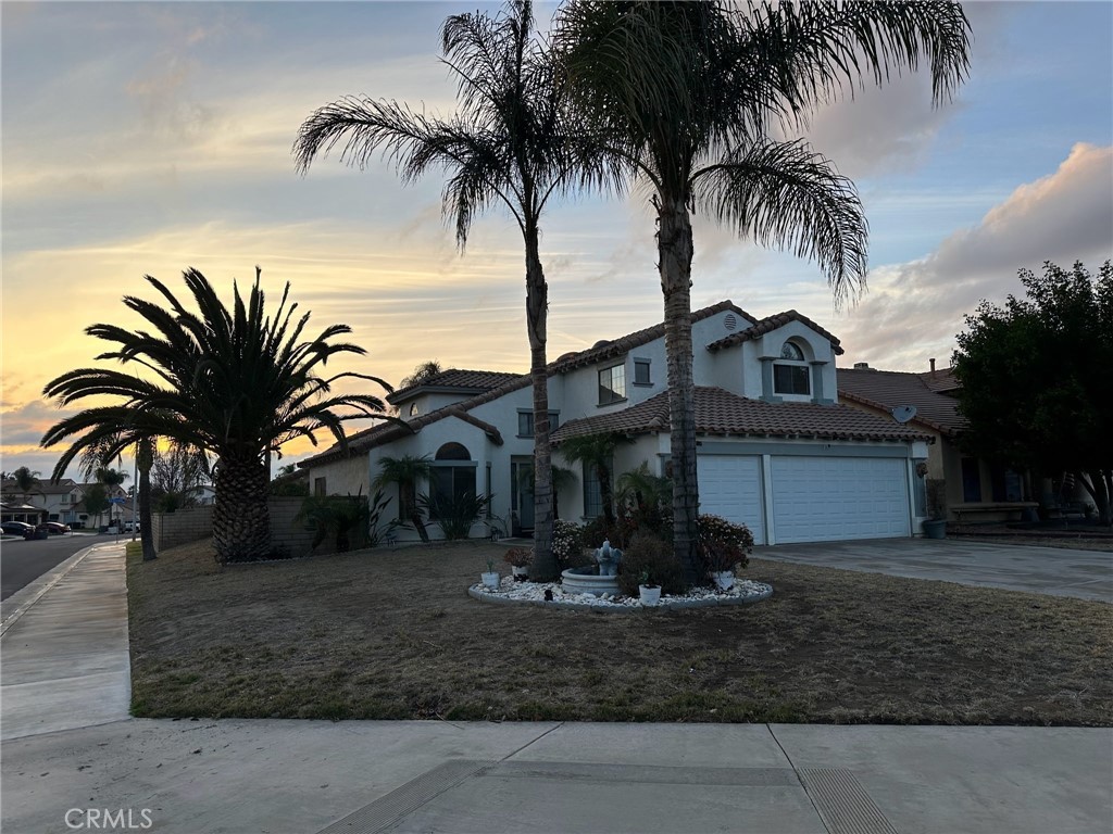 Welcome to 15585 Nueces Court, a spacious and well-appointed two-story home nestled on a desirable corner lot in the heart of Moreno Valley Ranch. Built in 1989, this 4-bedroom, 3-bathroom residence offers 2,131 square feet of comfortable living space, ideal for new home buyers seeking both functionality and style .Upon entering, you'll find a bright and airy living room complemented by high ceilings and a cozy fireplace, perfect for gatherings and relaxing evenings. The formal dining area provides an elegant space for entertaining guests. The home also features a separate gathering room, offering additional space for leisure and entertainment.The kitchen is designed for both everyday living and entertaining, with ample cabinetry and counter space. A convenient main-level bedroom and full bathroom are perfect for guests. Upstairs, the master suite boasts a large closet and an en-suite bathroom with both a tub and a separate shower. Two additional bedrooms and a full bathroom complete the upper level.Additional highlights include an indoor laundry room and a three-car attached garage, providing ample storage and convenience. Tile flooring throughout enhances the home's aesthetic appeal and ease of maintenance.Residents of Moreno Valley Ranch enjoy access to a variety of community amenities, including a pool, spa, clubhouse, and sports courts, all for a low HOA fee of $50 per month . The home is conveniently located near Riverside Community College and is within close proximity to schools, shopping centers, and parks.Don't miss the opportunity to make this charming property your new home.