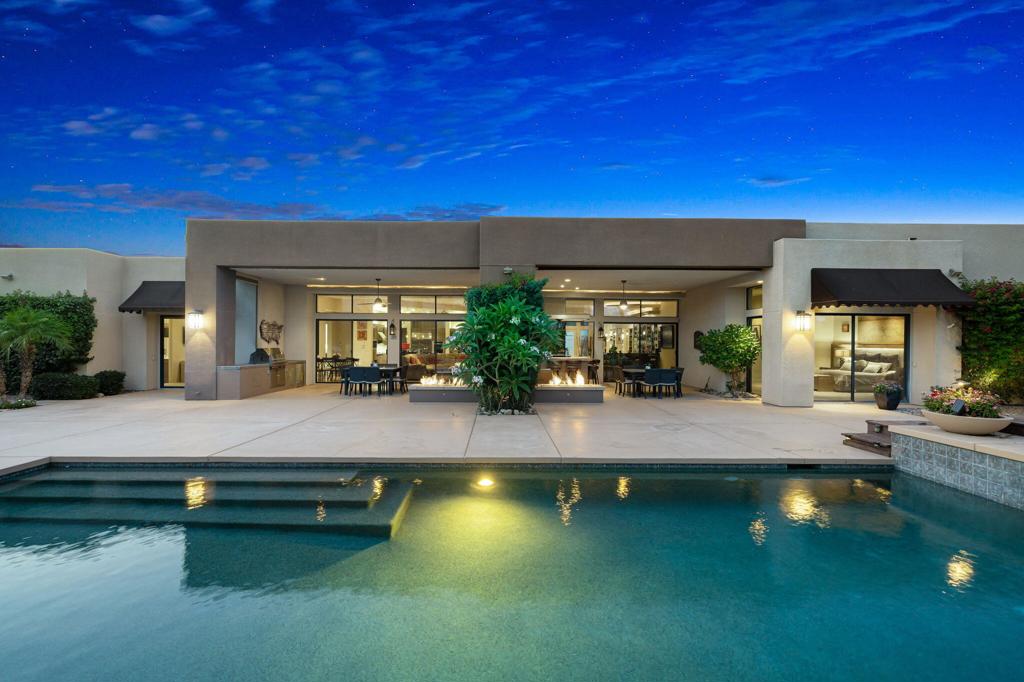Set on a quiet interior lot in the prestigious enclave of Sterling Estates, this home offers seamless desert living with refined design and privacy. Soaring 14-foot ceilings in the great room frame unobstructed Santa Rosa mountain sunsets, while mature, low-maintenance landscaping provides year-round color and seclusion.Outdoor living shines with dual fire pits, expansive covered patios, and alfresco bar --perfect for effortless entertaining. Inside, honed travertine floors lead through an open layout anchored by a chef's kitchen featuring double ovens and an oversized walk-in pantry.''An expansive full indoor bar enhances the home's entertainment appeal, offering a sophisticated space for hosting in style.''The luxurious primary suite includes a 350 sq ft custom wardrobe, dual water closets, a linen room, and direct patio access. Three ensuite guest rooms ensure privacy, while a dedicated office with dual workstations supports modern remote work.Sustainability meets convenience with a home-owned solar system, dual-pane low-E windows, and an oversized garage pre-wired for EV charging. Just minutes from world-class golf, Eisenhower Health, and fine dining, this is your private sanctuary in the heart of Rancho Mirage.