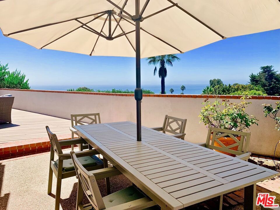 FURNISHED or unfurnished! Glorious views and beautiful updates make this Castellammare gem the ideal place to call home. Upon entering via a private courtyard patio, the front door opens to a generous living room with dining area and recently updated kitchen with stainless appliances, plenty of storage and a separate office/bonus area. The primary suite has two closets and a brand new bathroom; two additional bedrooms share another new bathroom. The living areas, primary and one of the secondary bedrooms each open to the large deck with stunning ocean, coastline and mountain views by day and breathtaking sunsets in the evening. Additional features include an electric vehicle charging outlet, newer A/C, two car garage, indoor laundry closet with washer/dryer and sink and gleaming hardwood floors. A peaceful respite in a coveted area of Pacific Palisades.