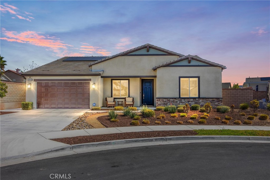 A stunning single-story Savannah model by Tri Pointe Homes, nestled in the sought-after Compass neighborhood of Audie Murphy Ranch in Menifee. This beautifully designed ranch-style home offers 2,800 sq. ft. of living space on an expansive 10,000+ sq. ft. lot, perfectly positioned at the end of a quiet cul-de-sac with breathtaking mountain views. From the moment you arrive, you’ll be impressed by the extra-long driveway, owned solar, drought-tolerant landscaping, and a charming front porch that sets the tone for this exceptional property. Step inside to soaring ceilings, 8’ doors, tall baseboards, recessed lighting, plantation shutters with bright natural lighting through out. Off the entry is a versatile flex room ideal for an office or easily converted to a 5th bedroom. Down the hall are three spacious secondary bedrooms, two with walk-in closets and one with mirrored wardrobe doors, all pre-wired with media packages. They share a stylish bath with dual sinks, quartz countertops, and a tub/shower combo. The heart of the home is the massive Great Room! The adjoining dining area and gourmet kitchen offer everything for the modern entertainer: a grand island with custom wood paneling, granite counters, soft-close cabinetry, double ovens, convection microwave, gas cooktop with pot filler, stainless steel hood, and walk-in plus butler’s pantry.