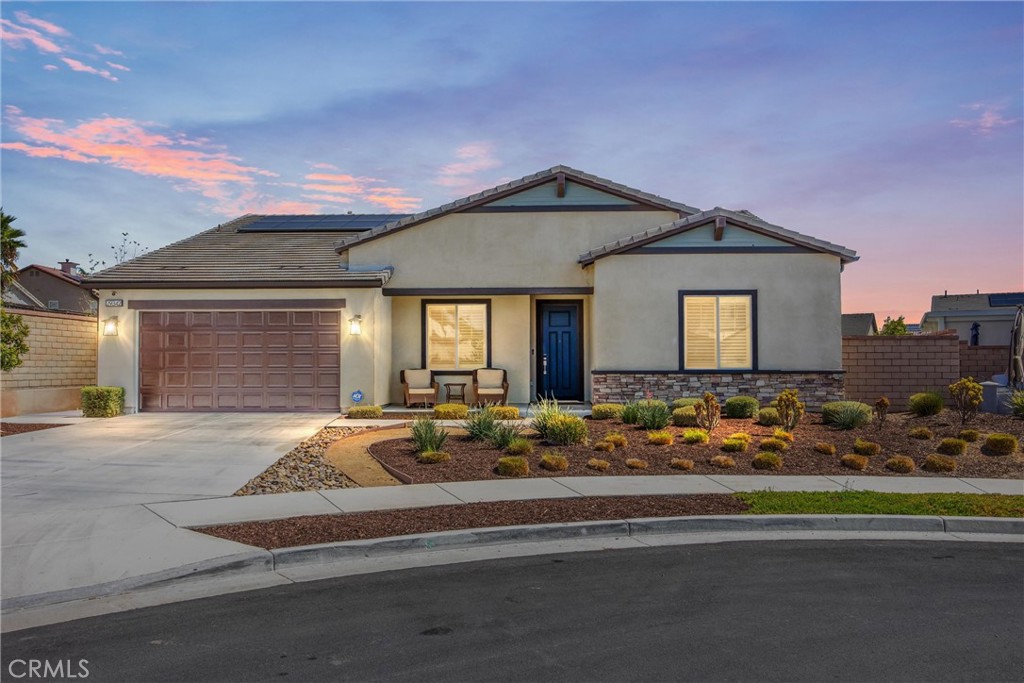 A stunning single-story Savannah model by Tri Pointe Homes, nestled in the sought-after Compass neighborhood of Audie Murphy Ranch in Menifee. This beautifully designed ranch-style home offers 2,800 sq. ft. of living space on an expansive 10,000+ sq. ft. lot, perfectly positioned at the end of a quiet cul-de-sac with breathtaking mountain views. From the moment you arrive, you’ll be impressed by the extra-long driveway, owned solar, drought-tolerant landscaping, and a charming front porch that sets the tone for this exceptional property. Step inside to soaring ceilings, 8’ doors, tall baseboards, recessed lighting, plantation shutters with bright natural lighting through out. Off the entry is a versatile flex room ideal for an office or easily converted to a 5th bedroom. Down the hall are three spacious secondary bedrooms, two with walk-in closets and one with mirrored wardrobe doors, all pre-wired with media packages. They share a stylish bath with dual sinks, quartz countertops, and a tub/shower combo. The heart of the home is the massive Great Room! The adjoining dining area and gourmet kitchen offer everything for the modern entertainer: a grand island with custom wood paneling, granite counters, soft-close cabinetry, double ovens, convection microwave, gas cooktop with pot filler, stainless steel hood, and walk-in plus butler’s pantry.