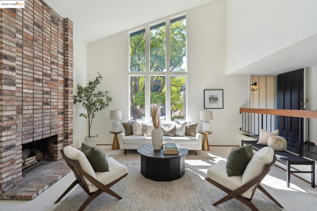 Lovingly cared for by the same family since 1972, this home is being offered for the first time in over 50 years. Nestled on a large, park-like lot, it feels like a private retreat. A graceful staircase leads to a patio set high in the trees, the perfect spot for morning coffee or evening sunsets. Another path winds up to a fruit orchard with a variety of trees to enjoy through the seasons. Inside, the layout is both practical and inviting with 4 bedrooms and 3 full baths. One bedroom and bath are thoughtfully located on the first floor, ideal for guests, a home office, or anyone who prefers single-level living. Sunlight fills the home through its many windows, creating warm, light-filled spaces with peaceful views of the surrounding greenery. After decades of careful stewardship, this home is ready to welcome its next owners to make their own lasting memories.