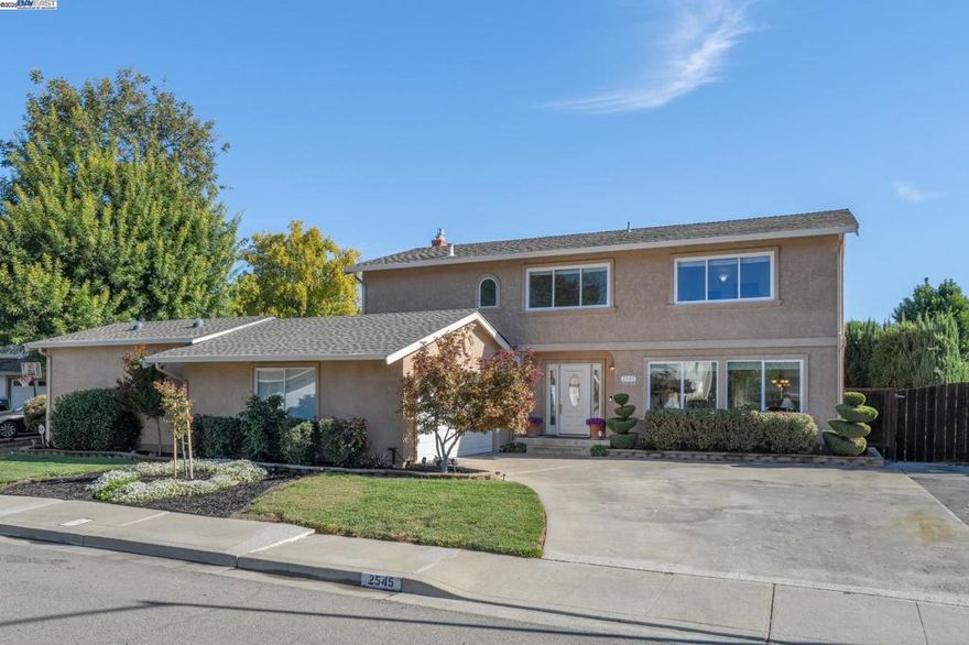 On a quiet cul-de-sac in Pleasanton’s Del Prado neighborhood, this upgraded 5BD/2.5BA contemporary offers easy California living - and membership in the Del Prado Cabana Club pool! A sunlit foyer with a high ceiling welcomes you to the 2310 SQFT home, leading to the living room with cozy fireplace, and beyond to the dining room with sliding doors onto the spacious deck for gracious indoor/outdoor living. The heart of the home is the updated kitchen with adjoining den with nearby powder room, and backyard access. Enjoy cooking in the spacious kitchen while family and friends gather around. In the expansive backyard, enjoy dining on the deck, unwinding in the hot tub, entertaining on the patio, or playing throughout the yard. Upstairs find the large primary suite featuring a huge walk-in closet and lovely ensuite bath. The additional four bright bedrooms have roomy closets and share a full bath. The oversized, 1,000+ sq. ft. garage accommodates four cars and includes a workshop, with gated RV or boat parking on both sides. With its size and layout, it also offers excellent potential for an ADU conversion. Nearby are top-rated schools, scenic trails, beautiful parks, and convenient BART and tech shuttle stops.