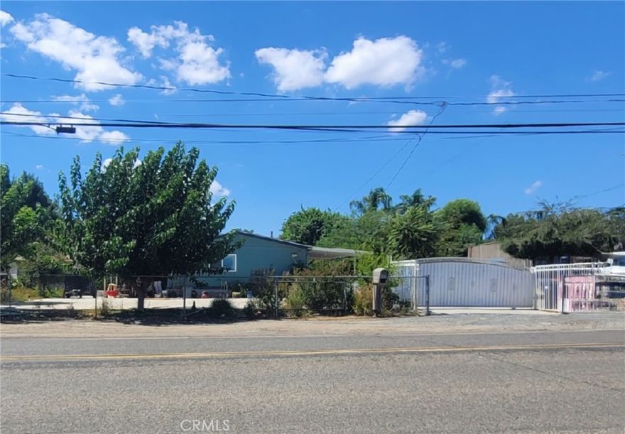 Beautiful 4-Bedroom, 2-Bath Manufactured Home on a corner lot, fully fenced and easy access from 74 HWY. Featuring new laminate flooring throughout, dual-pane windows, fresh interior paint, remodeled kitchen with elegant white quartz countertops.  Enjoy a large private yard with 2 covered patios ideal for BBQ's and gatherings, plus extended driveway to accommodate multiple vehicles, boat, trucks, RV's, and toys. Located near schools, shopping, and minutes from the 15 Fwy and 215 Fwy, making it convenient for commuters. The possibilities are endless!