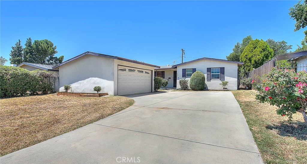 This 3-bedroom, 1-bath single-family residence offers 1,377 square feet of living space and is full of potential. The home features a cozy fireplace, perfect for relaxing evenings, and sits on a spacious lot with a large backyard—ideal for entertaining, gardening, or future additions. The two-car garage offers ample storage and parking. This property presents a wonderful opportunity for investors or buyers looking to renovate and add personal touches. Situated in a desirable neighborhood, this home is poised to be transformed into something truly special.