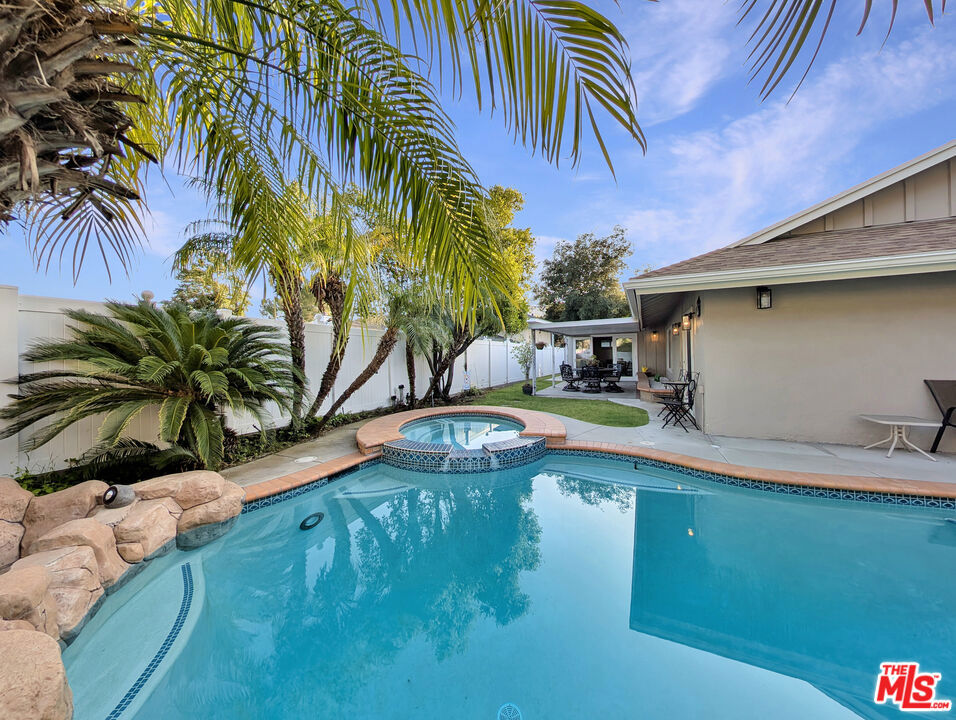 Tucked into Glendale's prestigious Montecito Park enclave, this fully furnished 4-bedroom, 2-bathroom smart home offers over 2,370 square feet of thoughtfully designed space, a stunning private backyard with pool and spa, and the kind of quiet luxury rarely available for lease. Set on a corner lot surrounded by mature trees and lush landscaping, the home combines privacy, scale, and seamless indoor-outdoor living. Skylights flood the interiors with natural light, highlighting two spacious living rooms, a formal dining area with fireplace, and a granite kitchen with stainless steel appliances, a breakfast nook, and generous cabinetry. Hardwood-style floors run throughout. The main-level bedroom opens directly to the backyard, where a sparkling pool, bubbling hot tub, grassy lawn, and covered patio create a completely private oasis ideal for entertaining or relaxing in comfort. Each bedroom is comfortably furnished with queen-sized beds, memory foam mattresses, and ceiling fans. One full bathroom is located downstairs, with a second three-quarter bath upstairs adjacent to the upper-level bedrooms. A vaulted bonus room with skylight offers the perfect setting for a family room, media lounge, or flexible entertaining space. Smart home features include keyless entry, a smart thermostat, and an integrated security system. Laundry is located in the garage, which also provides additional storage space and driveway parking. Central HVAC is included. Montecito Park is renowned for its serene hillside setting, convenient access to Montrose Village shops and the weekend farmers' market, and its close proximity to Deukmejian Wilderness Park and Descanso Gardens. The home is located within the Glendale Unified School District, which includes award-winning campuses such as Fremont Elementary and Crescenta Valley High School, both recognized as California Distinguished or National Blue Ribbon Schools. With convenient access to Pasadena, Downtown LA, and Burbank, the neighborhood offers a rare blend of serenity, accessibility, and academic excellence. Offered at $6,950/month, including professional gardening and weekly pool service. One-year lease. Fully furnished. Tenant pays utilities. Rental insurance is required, including $500K liability coverage. Security deposit is $10,000. No pets. No co-signers. All applicants are subject to credit, criminal, and eviction background checks. $50 application fee per adult. Proof of income and funds required. Shown by appointment only. Do not disturb occupants.