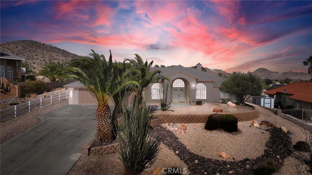 Custom-Built Deserada Home with Stunning Views & Timeless Charm! Pride of ownership shines throughout this meticulously maintained, custom-built Deserada home located in one of Apple Valley’s most desirable neighborhoods. Offering over 3,000 sq ft of living space, this spacious 4-bedroom, 3-bathroom home is designed for both comfort and elegance. Step inside and you’re greeted by abundant natural light, formal living and dining areas, and a warm, inviting atmosphere. The open-concept kitchen and great room are ideal for entertaining, complete with a cozy fireplace perfect for cool desert evenings. Enjoy your morning coffee in the sunny breakfast nook while soaking in breath taking views of the valley. The split floor plan ensures privacy for everyone. The luxurious primary suite features high ceilings, a fireplace, direct backyard access, a spacious bathroom with dual vanities, a soaking tub, tiled shower, and a generous walk-in closet. Step outside to your own oasis with a covered patio, low-maintenance desert landscaping, and beautiful views. The property also includes a 3-car garage with ample driveway parking. Nestled on a peaceful street with mature palms, octotillos, and an olive tree, this home offers a sense of seclusion while remaining conveniently close to St. Mary’s Hospital, shopping, restaurants, and the 15 freeway. Don’t miss your chance to own this Apple Valley gem—a perfect blend of comfort, style, and location!