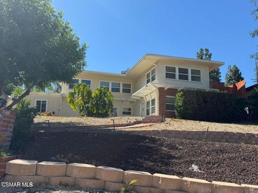 Perched in the scenic hills of coveted Woodland Hills, this charming two-story retreat offers the perfect blend of privacy, space, and contemporary comfort. Step inside to discover a flexible and functional layout, ideal for multi-generational living or work-from-home lifestyles. The lower level features a large great room with a decorative fireplace, a full bath and spacious bedroom with wall-to-wall closets with door to access front patio. The upper-level, sunlight pours into an open-concept living area with another decorative fireplace, that flows effortlessly into a well-appointed updated kitchen with a breakfast nook, plus a dining area, creating a warm and inviting atmosphere for gatherings. Laundry room off of the breakfast nook. Two bedrooms and a full bath (shower/bath combo) complete the upper level, offering comfort and serenity after a long day. Stainless steel appliances. Refrigerator included. Upper-level great room has a door to access large side patio area. Off kitchen, door that accesses back yard and private parking area. Storage area/room. Forced air heat and central air. Landscaping work in progress, backyard new sod installed. Plenty of street parking off Macfarlane plus private driveway off of Cass Ave, including a 1 car carport with near direct rear entry to the kitchen area.