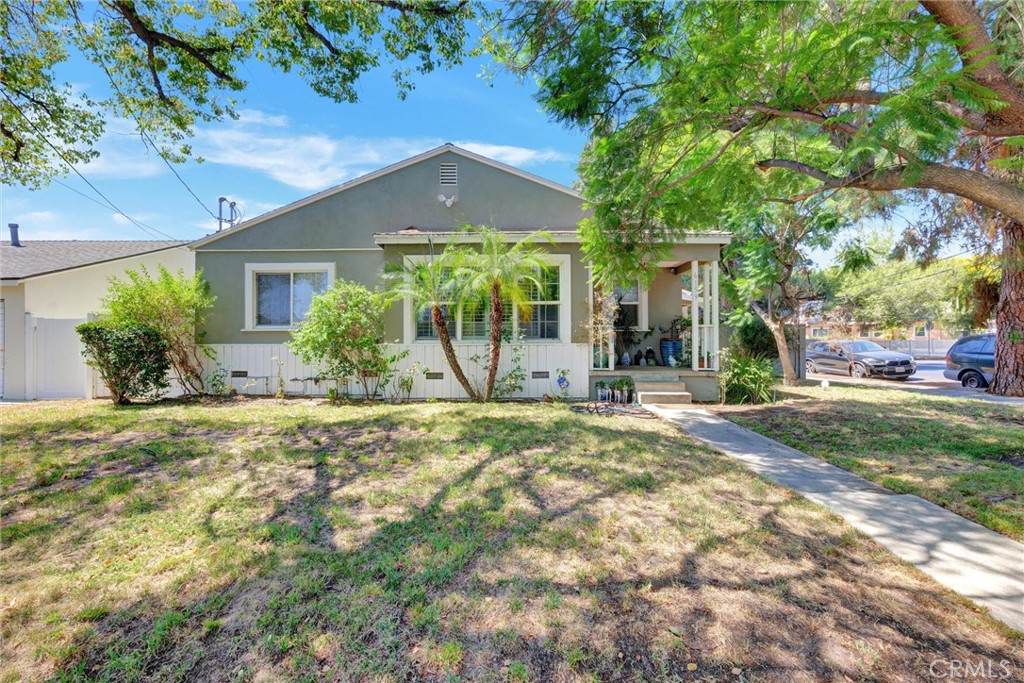 Discover a rare opportunity to own two homes on a desirable corner lot in North Hollywood. Set near the vibrant NoHo Arts District, this neighborhood is known for its theaters, galleries, and performance venues, along with its diverse community of artists. With a mix of residential and commercial spaces, plus vintage shops, cafes, and retro-inspired bars, North Hollywood offers both creativity and convenience, with easy access to transportation and plenty of parking. The main home preserves original character and charm, with four bedrooms and two bathrooms, featuring original wood floors, a spacious primary suite with direct access to the backyard, and a beautifully updated guest bathroom. Thoughtful upgrades and contemporary touches enhance its inviting character, while the 6,551 sq. ft. lot provides a parklike setting with mature fruit trees and shaded outdoor spaces. The detached garage has been fully converted into a brand-new, two-story, two-bedroom, two-bathroom 1076-square-foot residence. Finished in a modern contemporary style, it features a spacious living room, sleek kitchen with new appliances, and a stackable washer/dryer—all designed for the way we live today. Additional highlights include off-street parking for three cars and the flexibility to generate rental income or comfortably host extended living. With two distinct homes, abundant outdoor space, and a location at the heart of North Hollywood’s thriving arts and cultural scene, this property is a valuable and versatile find.