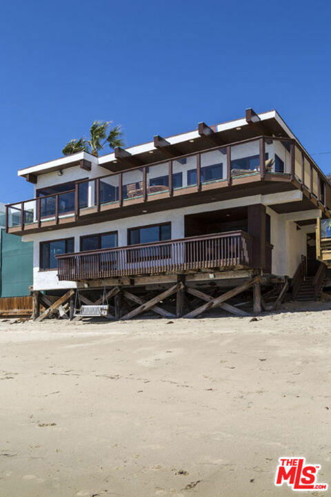 Great Malibu Road Beach home. The Dom Deluise Family Beach Home on the market for the first time in over 40 years. Gated entry leads you to a great entertaining seating and BBQ area. Entry level has very spacious open living, kitchen and dining area, all opening to an entertaining deck. There is also a powder room, and 2 bedrooms with full bath on this entry level. Lower level with oceanfront master suite, walk-in closet and bath with soaking tub, shower and sauna. 2 bonus rooms, great for office/gym/baby's room and additional full bath. Separate guest room/4th bedroom, walk-in closet and bath above garage with wet bar and deck. Easy beach access to a great sandy stretch of beach on Malibu Rd. Sale subject to existing Lease.