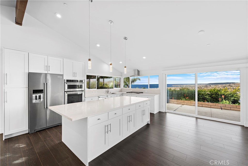 Perched on a ridge with premium views, this single level home is an amazing place to call home. Ocean views are captured from almost every major room in the home. Crisp views of Catalina Island, sunsets on the ocean horizon, Dana Headlands, city lights and etched coastline are undeniable. Rebuilt in approximately 2017, this home is stunning inside. Very clean, coastal-modern interior, featuring an amazing floor plan with one major great room under high vaulted ceilings, a centered two-way fireplace, three ensuite bedrooms plus a powder bathroom, interior laundry/mud room, and a rare three-car, side-by-side garage all on one level. Upon arrival, entry gates secure a front patio and yard leafing to double French door entry. Inside, dining, kitchen, and living all share one amazing ocean-view living space. The kitchen offers a large island, white shaker cabinets, quartz counters, stainless appliances and picture windows framing an amazing view beyond. Wood-like porcelain tile plank flooring flows throughout the entire home with exception to the brand-new carpeted bedrooms. All bedrooms have oversized closets and updated bathrooms. The master suite offers direct ocean views and a spa-like master bathroom with jetted tub, walk-in ocean-view shower with dual shower heads, dual vanities, and a towel heating bar. Other values include all-new interior & exterior paint (just completed), newer recessed lighting and vinyl windows, newer exterior hardscaping and (2) stubbed in-line gas lines in rear yard (fire pit and/or BBQ), new floor coating in garage, newer A/C & ceiling fans, wired for alarm, custom window treatments, raised settee patio, and heavy-duty security gates. Ideally located on an ocean-view corner lot and single-loaded street, the home is just minutes from all San Clemente has to offer. For those in pursuit of a laidback, beachy lifestyle close to amazing beaches and easy access, fine dining at new and trending restaurants, convenient nearby shopping, the 2.5 mile beach trail, world-class surfing, the SC pier and historic downtown, and a great community with highly-rated schools, this is your opportunity!