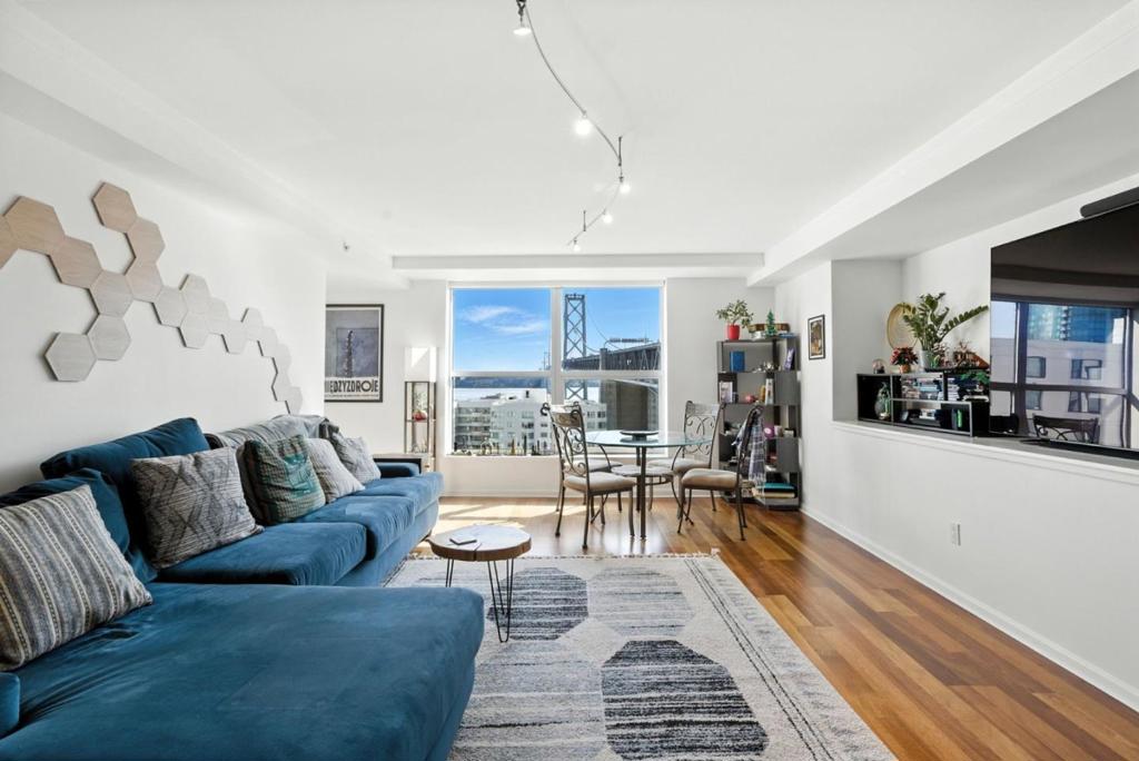 Welcome to Residence 1413 at The Bridgeview a stylish and sun-drenched 1-bedroom, 1-bathroom condo in the heart of South Beach. This high-floor unit boasts floor-to-ceiling windows framing sweeping views of the Bay Bridge and city skyline, creating the perfect backdrop for modern San Francisco living. Step into an open-concept living space featuring hardwood floors, a sleek kitchen with granite countertops, stainless steel appliances, and ample cabinetry. The spacious bedroom offers generous closet space, and the bathroom is finished with elegant tile and fixtures. In-unit laundry and 1-car deeded parking complete the package. The Bridgeview is a full-service building offering 24/7 concierge, a rooftop terrace with panoramic views, a heated pool, hot tub, fitness center, and a BBQ area all just steps from the Embarcadero, Ferry Building, Oracle Park, and world-class dining and shopping. Whether you're a first-time buyer, a city commuter, or looking for a pied-à-terre, this is your opportunity to own in one of San Franciscos most desirable neighborhoods.