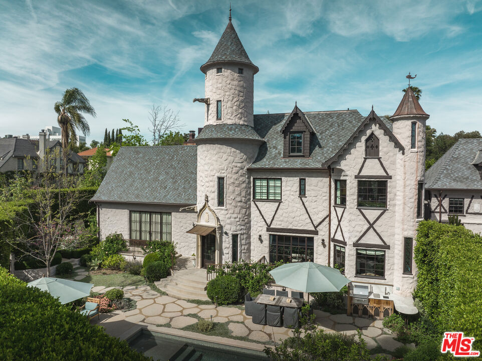 Chateau Lemoine 1926. An exceptional example of Storybook architecture. Considered to be the "crown jewel" of "Brookside" (a bucolic community of tree-lined streets featuring single-family residences in a range of Period Revival styles), so named after the Arroyo De Los Jardines (Brook of the Gardens) the year-round stream that runs through the area and bisects numerous properties (necessitating bridges to span the waterway affording access to the backyards). Extensively remodeled, the 4-bedroom home with 1-bedroom guest house, features a dramatic living room with vaulted and beamed ceiling, minstrel balcony and carved stone fireplace; an exhibition kitchen with carved stone hood surround and pro-style appliances; guest house has its own kitchen, living room and bedroom suite; formal dining and family room opening to the kitchen; saltwater pool and spa; beautifully manicured landscape and numerous fruit trees; serene seating area with firepit at the stream; luxurious finishes from Exquisite Surfaces (and other designer sources) and endless period elements. ALSO AVAILABLE FOR LEASE