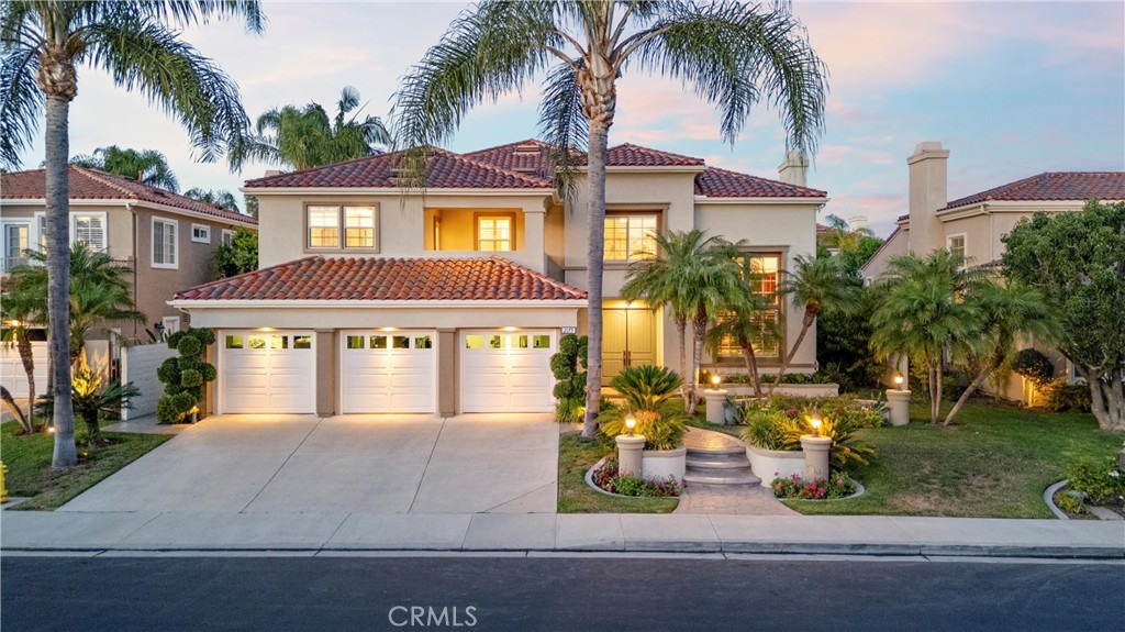 Welcome to 2175 Palmer Place, a grand executive estate tucked within the guard-gated and prestigious San Marino community. This stately 5-bedroom + office, 4.5-bathroom residence offers 4,461 square feet of thoughtfully designed living space on an expansive 8,400 square foot lot. Upgraded throughout with rich wood flooring and plush carpet, fresh paint, thick crown moldings and baseboards, plantation shutters, and elegant wainscoting, the home blends timeless elegance with modern comfort. A dramatic double-door entry leads into a sweeping Foyer featuring soaring ceilings, a striking curved staircase, and a Formal Living Room with a fireplace and two-story windows. The Formal Dining Room opens directly to the backyard, ideal for effortless indoor-outdoor entertaining. At the heart of the home lies an expansive Great Room, combining a chef’s Kitchen with quartz countertops, center island with bar seating, a sunny Breakfast Nook, Bluestar range, SubZero refrigerator, and walk in pantry, all flowing into a spacious Family Room with a built-in media center. The resort-style backyard is a true entertainer’s dream, showcasing mature tropical landscaping, a spa, putting green, custom stone fireplace, outdoor living pavilion with an outdoor kitchen - including BBQ, hood, and fridge - plus extensive brick and stone hardscaping and professional landscape lighting. Downstairs, enjoy a private ensuite bedroom, a convenient Powder Room, and a French country-inspired Laundry Room with a stylish sink and tile backsplash. A stately Executive Office impresses with soaring ceilings, custom built-ins, and a sliding ladder. Upstairs, the luxurious Primary Suite offers a triple-sided fireplace, private retreat, a large walk-in closet, and a spa-like bathroom with jetted tub, walk-in shower, dual vanities, and a makeup area. Three additional bedrooms complete the upper level - one with an ensuite bath and another with a large covered balcony. Additional highlights include a 3-car garage, a spacious driveway, low HOA dues, and no Mello-Roos. Ideally located just minutes from Ladera Elementary, The Market Place, Tustin Ranch Golf Club, and Peters Canyon Regional Park, 2175 Palmer Place presents a rare opportunity to own a refined estate in one of Orange County’s most sought-after communities.