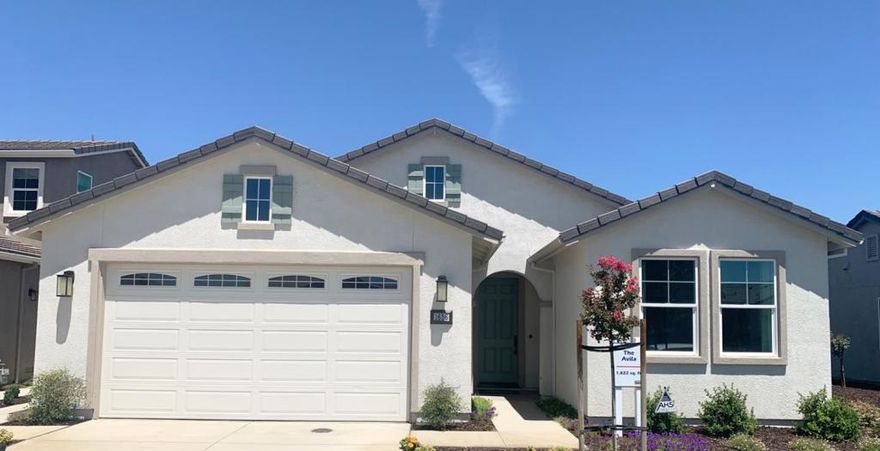 This beautifully upgraded model home showcases over $50,000 in designer selections and premium finishes. Featuring elegant Smoked Gray cabinets throughout with an extended kitchen buffet, granite countertops, and under-cabinet lighting, the gourmet kitchen is as functional as it is stunning. The upgraded flooring throughout adds a seamless flow to every room, while the upgraded laundry package with upper and lower cabinetry provides style and convenience. The luxurious primary suite includes a spa-inspired bathroom complete with a stunning custom backsplash. Thoughtful enhancements continue throughout the home, including built-in speakers in the entry and great room, a fully installed alarm system, and all appliances included for a true move-in ready experience. Outdoor living shines with landscaped front and back yards, irrigation, and a concrete patio. Exceptional energy-efficient features include central air & heat, tankless water heater, and pre-plumbing for soft water.