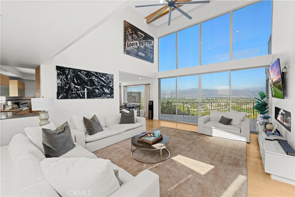 $200,000 price adjustment! Won't last long! Welcome to this stunning AIA designed modern residence South of Ventura Boulevard perched above Studio City's Silver Triangle with showstopping panoramic city-light sunrise sunset views. This one-of-a-kind 2 story residence with ADU boasts 5 bedrooms 5 baths and 2800 square feet masterfully framed with soaring 18ft ceilings, expansive walls of glass and effortless indoor-outdoor living to multiple large viewing decks and backyard. The main 2200 square foot residence centers around a picture perfect 2-story dramatic gallery inspired Great Room fabulous for art with full wall of glass and linear fireplace. The chef-inspired designer kitchen is perfect for everyday living and elevated entertaining boasts quartz counter tops, high end appliances, center-island seating open to the dining area with additional corner window to devour the views. A main floor ensuite bedroom & additional downstairs bedroom and bath makes this floorplan ideal offering 2 bedrooms up, 2 down. Upstairs divided by a suspended walkway both en-suite bedrooms are strategically positioned to deliver mesmerizing sights of a glorious sunrise or the glistening city lights. The primary includes a massive private balcony to soak it all in, custom-fitted walk-in and gorgeous bath with loads of glass luring warm natural light with dual vanity. A separate 600 square foot 1 bedroom 1 bathroom ADU has its own washer, dryer and private viewing deck that captures the same sweeping views as the main house; ideal for guests, music studio, or income potential. This is truly a one of a kind architectural gem not to be missed designed by renowned architect Jon Brouse.