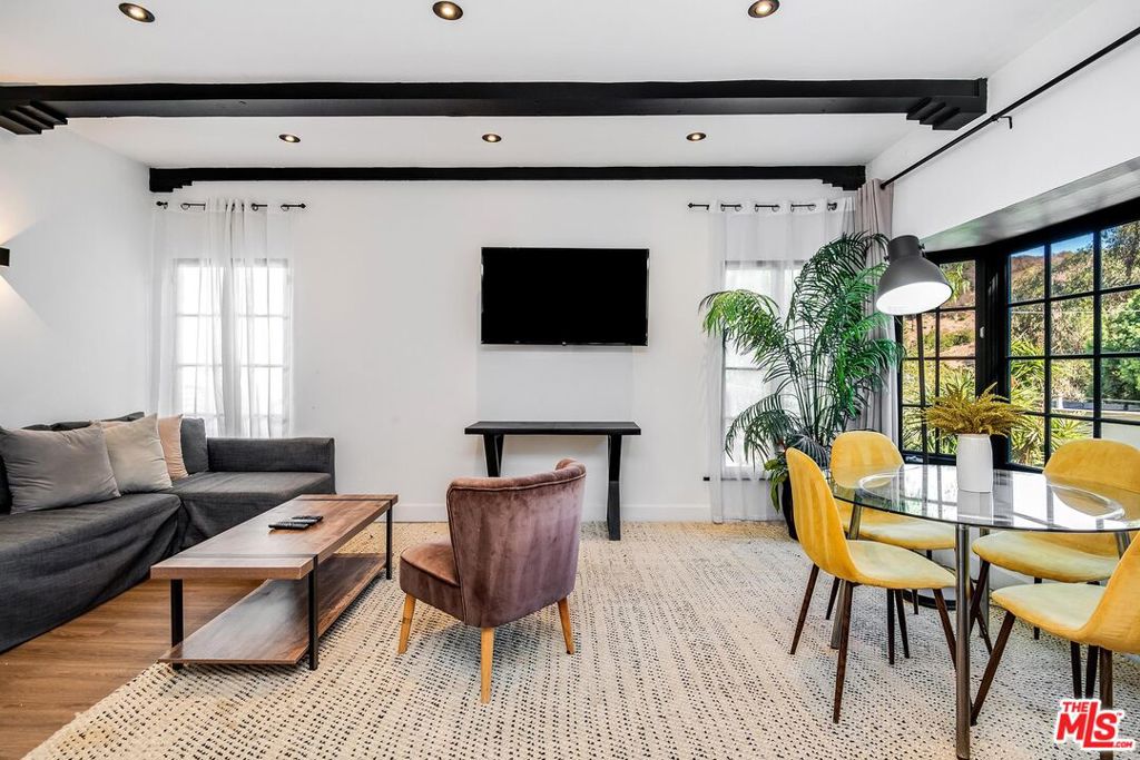 Tucked away on a private, tree-lined street in Beverly Hills Post Office, this impeccably renovated 3-bedroom, 2-bathroom home offers a perfect blend of modern indulgence and natural tranquility. The expansive open living space is bathed in natural light, while the updated kitchen features stainless steel appliances and stylish finishes. A secluded second-floor primary bedroom with a spacious private balcony, ideal for soaking up the sun in serene solitude. A stunning rooftop deck provides sweeping views, ideal for both entertaining and relaxation. Surrounded by lush greenery, the home offers ultimate privacy yet is just moments from Beverly Hills' most exclusive destinations. Enjoy the outdoors with nearby Coldwater Canyon Park and Franklin Canyon Reservoir offering scenic hiking trails, relaxing afternoons in the park, and serene reservoir views. This property presents a rare opportunity to live in one of the most coveted zip codes in the world.
