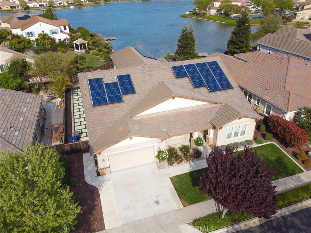 Imagine awakening to a majestic sunrise, glistening over the water and your favorite morning cup. This could be you every day, enjoying luxurious lakefront living in your new home at 109 Clear Lake Ct. Nestled on a quiet, tree-lined cul-de-sac, this stunning 6 bed/4.5 bath residence offers 4191 square ft of spectacular living space on a prime lakefront 1/4+ acre lot and is fully equipped with state-of-the-art solar and battery storage systems for off the grid energy independence. The moment you enter this enchanting home, bathed in natural light, you feel its warmth and charm. You can see yourself gathering with family and friends to enjoy breathtaking views of the glistening lake. The ambiance beckons you to the serene backyard oasis where there is something for everyone. The outdoor living space is beautifully landscaped and features an extended covered patio with built in fans and recessed lighting, lush organic fruit trees, low maintenance green space, and a 2nd deck overlooking the water. There is plenty of room for your own outdoor kitchen, children's play areas, and dog runs for your fur babies. Indoors, opulent multi-generational living and guest space abounds. Downstairs features a bedroom with ensuite bath and generously sized Jack and Jill bedrooms with shared bath. A private corridor leads to your impressive Primary Suite featuring a luxurious ensuite bath, spacious walk-in closet, water views and direct access to your outdoor sanctuary. Communal areas include an elegant Formal Dining Room, a deluxe Chef’s Kitchen featuring Jenn Air appliances and a 6-burner range, large nook and open family room with direct patio access. Upstairs offers a huge bonus room overlooking the lake, 2 additional spacious bedrooms and a shared bath. The 3-car tandem garage with epoxy flooring and finished walls provides lots of space for your cars and toys, a 40 amp/240 volt plug for your EV, and a tankless water heater. And with dual solar panels you won't be affected by rolling blackouts. Look forward to enjoying this opulent lakeside home while taking advantage of the tremendous savings from paid-in-full high end solar and battery storage systems.