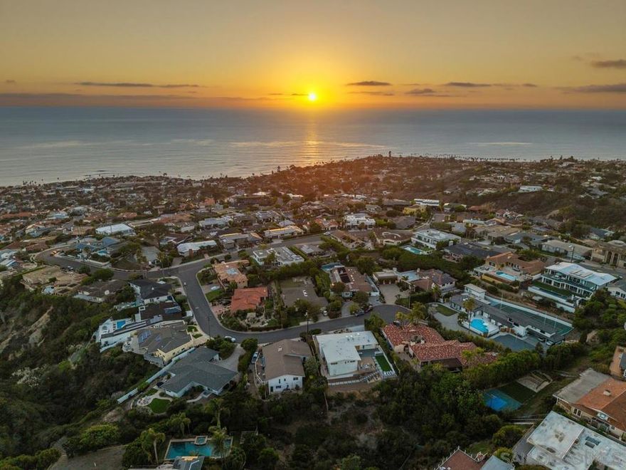 A rare coastal masterpiece—this reimagined single-level La Jolla retreat celebrates timeless mid-century design, modern luxury, and truly breathtaking ocean views. Perfectly sited on a private cul-de-sac, the home captures sweeping panoramas of the Pacific that stretch from sunrise to golden sunset, framed by walls of glass and soaring vaulted ceilings. Experience effortless indoor-outdoor living with a designer kitchen featuring rift-cut oak cabinetry, terrazzo floors, and Caesarstone counters that flow seamlessly to expansive terraces complete with an outdoor kitchen, fire pit, and multiple lounge areas. The spa-inspired primary suite offers a wet room with dual showers and a soaking tub overlooking lush canyon vistas. With room for a pool or ADU, this rare sanctuary delivers privacy, sophistication, and some of La Jolla’s most captivating ocean views—an extraordinary offering of coastal elegance.