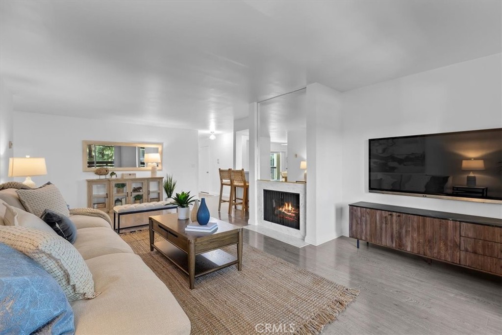 Welcome to this beautifully updated condo in the heart of Rancho Palos Verdes! This private and spacious 2-bedroom, 2-bath unit offers a fantastic layout, featuring a large living area with a cozy fireplace, sliding glass door, a built-in bar, and a private balcony - perfect for enjoying your morning coffee or winding down in the evening. The kitchen has been tastefully updated with granite countertops, tile flooring, stainless steel sink, range, and dishwasher, and ample cabinet space. The primary suite includes three closets for generous storage and an en-suite bathroom. Across the way, the second spacious bedroom features its own walk-in closet and easy access to the full hallway bathroom. A separate dining room with a sliding glass door brings in natural light and offers direct access to the interior of the community. Additional highlights include convenient in-unit laundry, two side-by-side parking spaces in a gated garage, and the complex pool. Located just minutes from shopping, restaurants, parks, and award-winning Palos Verdes schools, this move-in-ready condo truly checks all the boxes!