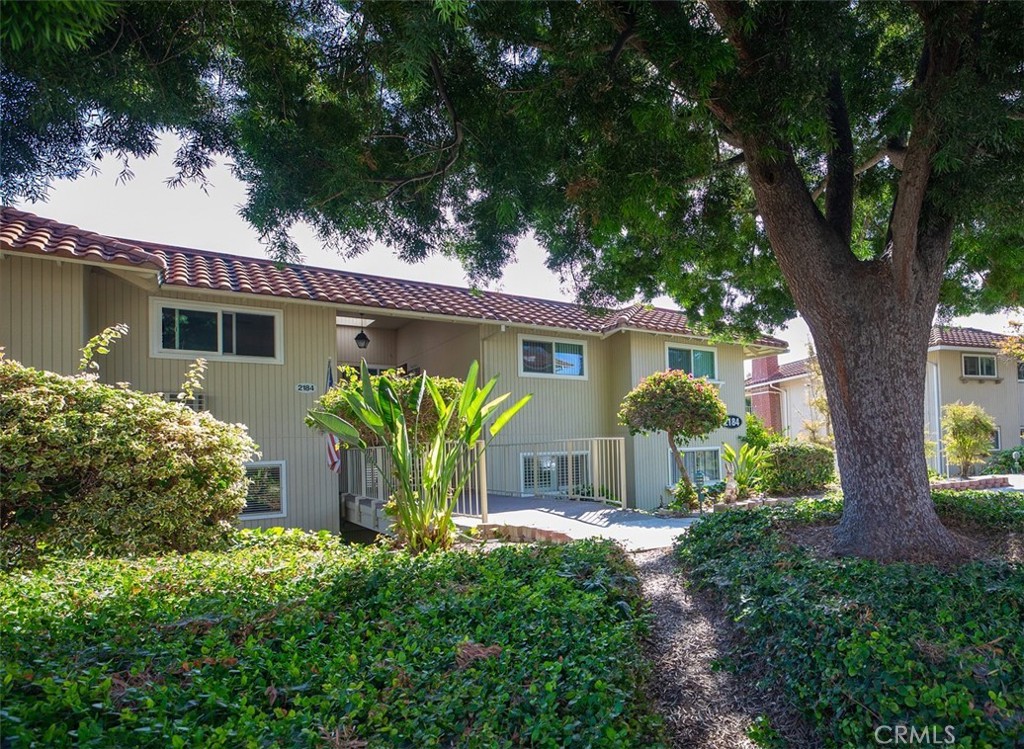 OPEN HOUSE CHANGED TO SUNDAY 9/7 This 2 bedroom/ 2 bathroom co-op is located near Gate 5 and has a nice eastern outlook from the living-dining area and from the sunny wraparound balcony. The bedroom windows in the front of the home receive afternoon sun for a bright house throughout the day and nice cross breezes with east/west facing windows.
There are 8 steps down to the entrance and inside the home gives you ample space with a large living area, a separate dining room, two bathrooms and two well-proportionated bedrooms. The kitchen has a window facing the entry and an open side facing the dining area and balcony. The unit has Plantation shutters and stack washer/dryer that is conveniently located in the hall closet. (included) The spacious living/dining area has a gas fireplace and windows and slider facing out to the long balcony.
Both bedrooms are carpeted and have good sized closets. The large primary bedroom suite has mirrored closet doors and walk-in shower behind a private door.
Carport with additional storage closets is located directly across from the unit.
The Village offers outstanding amenities: golf cart friendly, 27 hole golf course, Par 3 golf course, horse stables, equestrian center, 6 pools, Clubhouses, woodworking shop, pickle ball, tennis, paddleball, bocce ball, 2 garden centers, over 250 clubs and so much more! Close to restaurants, shopping, medical facilities.
All Information deemed reliable but to be verified by Buyer.