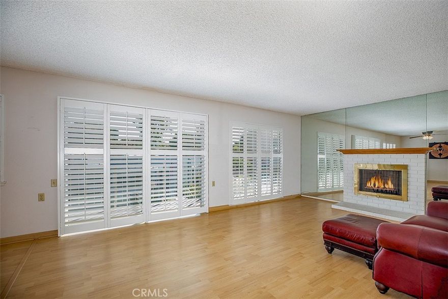 OPEN HOUSE CHANGED TO SUNDAY 9/7   This 2 bedroom/ 2 bathroom co-op is located near Gate 5  and has a nice eastern outlook from the living-dining area and from the sunny wraparound balcony. The bedroom windows in the front of the home receive afternoon sun for a bright house throughout the day and nice cross breezes with east/west facing windows. 

There are 8 steps down to the entrance and inside the home gives you ample space with a large living area, a separate dining room, two bathrooms and two well-proportionated bedrooms.  The kitchen has a window facing the entry and an open side facing the dining area and balcony. The unit has Plantation shutters and stack washer/dryer that is conveniently located in the hall closet. (included) The spacious living/dining area has a gas fireplace and windows and slider facing out to the long balcony.

Both bedrooms are carpeted and have good sized closets.  The large primary bedroom suite has mirrored closet doors and walk-in shower behind a private door.

Carport with additional storage closets is located directly across from the unit.

The Village offers outstanding amenities: golf cart friendly, 27 hole golf course, Par 3 golf course, horse stables, equestrian center, 6 pools, Clubhouses, woodworking shop, pickle ball, tennis, paddleball, bocce ball, 2 garden centers, over 250 clubs and so much more! Close to restaurants, shopping, medical facilities.

All Information deemed reliable but to be verified by Buyer.