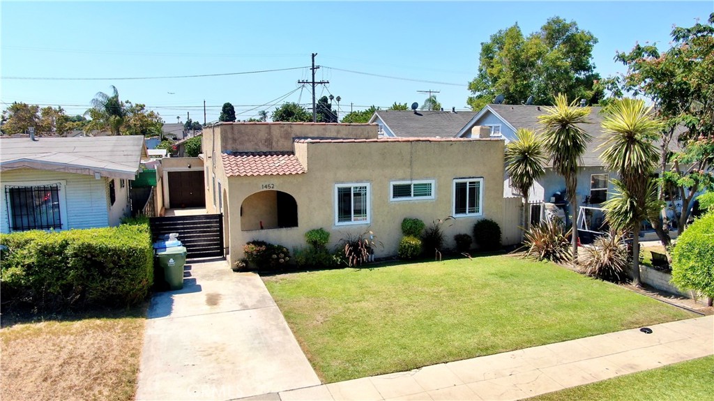 Welcome to 1452 W 52nd Street, a beautifully remodeled Spanish-style home that perfectly blends timeless charm with modern upgrades. This 3-bedroom each with their individual AC unit, 2-bathroom residence offers an inviting open floor plan with abundant natural light and elegant laminate wood flooring throughout. Enjoy the convenience of a detached garage and the privacy of a spacious, enclosed backyard—ideal for entertaining, gardening, or simply relaxing. Situated in the vibrant Chesterfield Square neighborhood of Los Angeles, this single-story home offers easy access to local shops, dining, and major freeways, making it perfect for both first-time buyers and those seeking a move-in-ready property with long-term value.