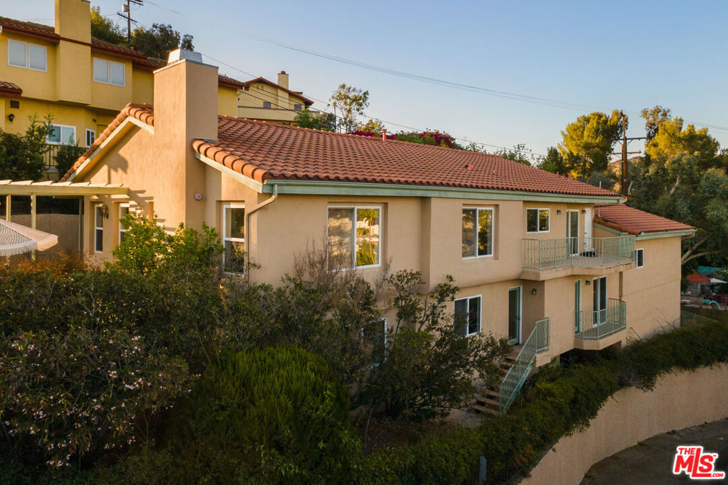 Perched high above Eagle Rock with commanding 180-degree easterly views, this expansive 4-bed, 4-bath residence offers over 3,000 sq. ft. of living space with comfort and connection in mind. A rare find in the hills, the home boasts an extra-long driveway with secured gate access, and a 3-car garage, a luxury for families with multiple cars, boats, hobbyists needing workshop space, or professionals seeking a home studio. Inside, you'll discover a freshly painted, spacious, light-filled floor plan that's a blank canvas ready to be tailored to your vision. Whether you're dreaming of a designer showcase or a multi-generational forever home, the possibilities are endless. The thoughtful layout provides room for everyone; three of the four generously sized bedrooms feature en-suite bathrooms, and seamless flow between indoor and outdoor spaces. Unlimited entertaining options with al fresco dining areas, multiple balconies, perfect taking in dramatic canyon and city vistas of Occidental College and the famed Eagle Rock. Enjoy an expansive kitchen loaded with storage, an extra large butcher block island, breakfast nook, and walk-in pantry for all your Costco hauls. Downstairs opens up to a large flex space, potential family room/game room/home gym, with two more bedrooms and bathrooms with no shortage for storage. Zoned for Eagle Rock Elementary this home captures the essence of NELA living: room to grow, views to inspire, and a lifestyle to savor. Just moments from numerous eateries and watering holes such as Senor Fish, Zweet Cafe, The Capri, Vidiots, PDA coffee, Sprouts and Target. Welcome home!