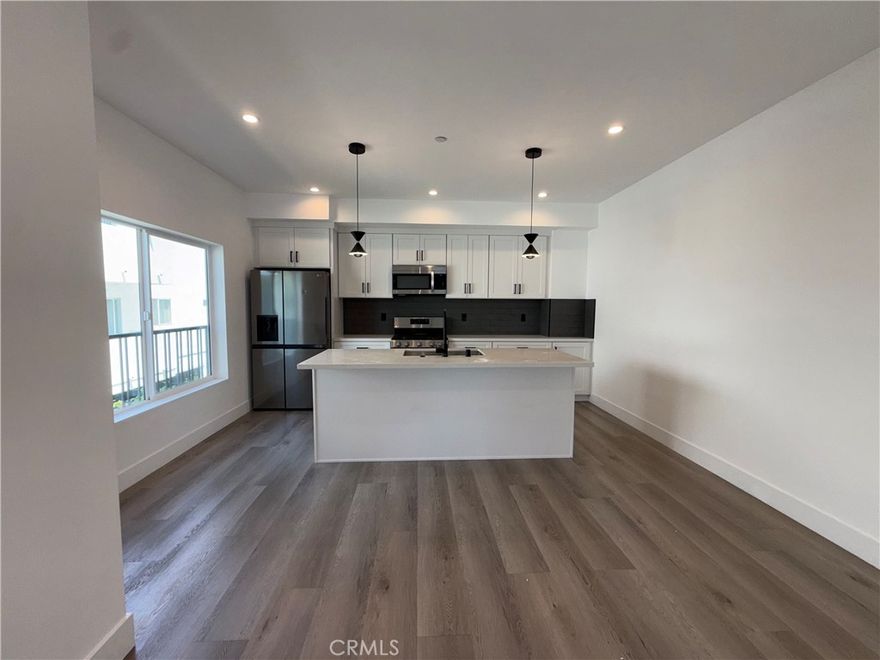 Built in 2023, this modern 3-bedroom, 2-bath home is located in a quiet, gated community of only four units. Enjoy an open floor plan with high ceilings, large windows, and natural light throughout. The sleek kitchen features contemporary cabinetry and stainless steel appliances, flowing seamlessly into the spacious living and dining areas. Primary suite includes an elegant bathroom and generous closet space. Designed for comfort and low-maintenance living, this boutique community offers privacy and a peaceful atmosphere rarely found in newer developments. Conveniently located near shops, dining, and major freeways—move-in ready and truly a must-see.