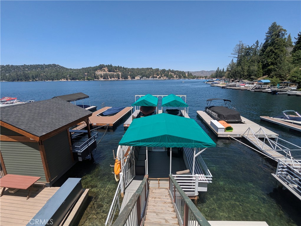 Own a Prime Piece of Paradise in the Palisades! This 1/2 double dock is perfectly positioned just west of Emerald Bay in the calm waters of the Palisades shoreline. Enjoy low-maintenance Trex decking, a dock house for secure storage, a dedicated fridge area, and storage under the dock seating. Just steps away from your dock you’ll find a sandy beach and a community Trex deck, perfect for lakeside lounging and fun in the sun! What truly sets this dock apart? Electricity—a rare feature on Lake Arrowhead! Power up your refrigerator, run a blender for lakeside cocktails, charge your phone, or plug in your favorite devices with ease.
Dock S-486-B has everything you need: deep, calm waters (park your boat with ease), dock house and storage, a private beach and additional deck, and electricity. Don’t miss this rare opportunity to upgrade your summer lifestyle!