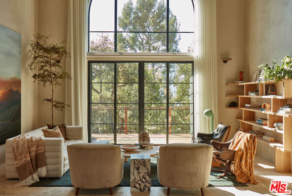 A Rare Architectural Gem in Topanga's Prestigious PO Tract. Completely remodeled, thoughtfully designed, and tastefully furnished in 2022 by one of Los Angeles' top designers, this architectural masterpiece sits in Topanga's most sought-after neighborhood the PO Tract. Located on a quiet, private road with no through traffic, this one-of-a-kind home offers the option to be sold fully furnished. Featured on Remodelista and used as a backdrop for premium lifestyle brand photo shoots, the home showcases handcrafted finishes with a distinctly LA artisanal flair. Set on a fully fenced half-acre lot, the property includes a newly built pool, luxurious outdoor lounge, and an expansive deck perfect for al fresco dining and taking in breathtaking sunset views. Surrounding the home are mature oak trees and abundant edible landscaping, including blueberries, blackberries, peaches, lemons, mandarins, asparagus, and two raised garden beds for year-round cultivation. Located within walking distance to Topanga State Park and just five minutes from town, this home offers the best of canyon living with easy access to nature and community. Enter through a custom-carved front door into a dramatic double-height entry and living room framed by sweeping views of the canyon and oaks. The main level includes the kitchen, dining area, a cozy family room/den, and a full bathroom. Upstairs, the primary en-suite bedroom feels like a serene retreat, complete with a walk-in closet and tranquil ambiance. A second en-suite bedroom features a custom loft, while a third bedroom--currently used as an office and yoga room--offers generous closet space. The upstairs also includes a dedicated laundry area. All wood details were sustainably sourced through Angel City Lumber, adding an environmentally conscious touch to the home's elegant aesthetic. Additional features include a spacious two-car garage with direct home access, a large basement for storage or creative projects, an extra parking area for 3--4 cars, and a separate gardening shed. The lower yard is ready for a potential ADU addition. The home also generates extra income through photo shoot rentals. Designed with effortless indoor/outdoor flow, this home is ideal for entertaining or quiet canyon living. Whether you're hosting large gatherings or enjoying peaceful family moments, this artistic retreat is truly one of the most beautiful and unique homes in all of Topanga--a must-see property.