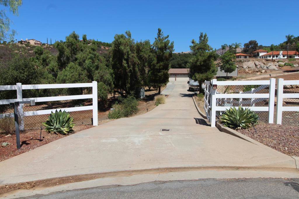 Welcome to this exquisite single-story ranch-style home in the coveted Blossom Valley community, offering 4 bedrooms, 3 baths, and approximately 2,774 sq. ft. of living space on a private, gated 3.28-acre lot. A long driveway leads to the attached 3-car garage, citrus trees, new turf, chicken coop, and full RV hookups, while inside the formal entry opens to spacious living and dining rooms, a completely upgraded chef’s kitchen with professional-grade stainless steel appliances, and a family room with fireplace that seamlessly connects to the covered patio, sparkling pool and spa, and a gazebo with breathtaking lookout views. The master suite is a true retreat with a luxurious bath and custom walk-in closet organizer, and the home is enhanced by an owned 40-panel solar system by Baker Electric, dual York electric heat pump systems with Nest thermostats, a Caldera Vacanza spa, a Waterboy whole-house filtration system, and newly installed automatic garage doors. Ideally located near Sycuan Casino Resort, Steele Canyon Golf Club, and El Capitan Preserve hiking trails, with easy access to the shopping and dining of El Cajon, Rancho San Diego, and Alpine, plus just a short drive to San Diego beaches, the Gaslamp Quarter, and the mountains of Julian, this rare property offers the perfect balance of luxury, efficiency, and the relaxed lifestyle of Southern California ranch living.