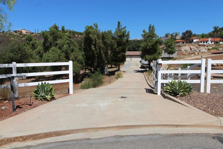 Welcome to this exquisite single-story ranch-style home in the coveted Blossom Valley community, offering 4 bedrooms, 3 baths, and approximately 2,774 sq. ft. of living space on a private, gated 3.28-acre lot. A long driveway leads to the attached 3-car garage, citrus trees, new turf, chicken coop, and full RV hookups, while inside the formal entry opens to spacious living and dining rooms, a completely upgraded chef’s kitchen with professional-grade stainless steel appliances, and a family room with fireplace that seamlessly connects to the covered patio, sparkling pool and spa, and a gazebo with breathtaking lookout views. The master suite is a true retreat with a luxurious bath and custom walk-in closet organizer, and the home is enhanced by an owned 40-panel solar system by Baker Electric, dual York electric heat pump systems with Nest thermostats, a Caldera Vacanza spa, a Waterboy whole-house filtration system, and newly installed automatic garage doors. Ideally located near Sycuan Casino Resort, Steele Canyon Golf Club, and El Capitan Preserve hiking trails, with easy access to the shopping and dining of El Cajon, Rancho San Diego, and Alpine, plus just a short drive to San Diego beaches, the Gaslamp Quarter, and the mountains of Julian, this rare property offers the perfect balance of luxury, efficiency, and the relaxed lifestyle of Southern California ranch living.